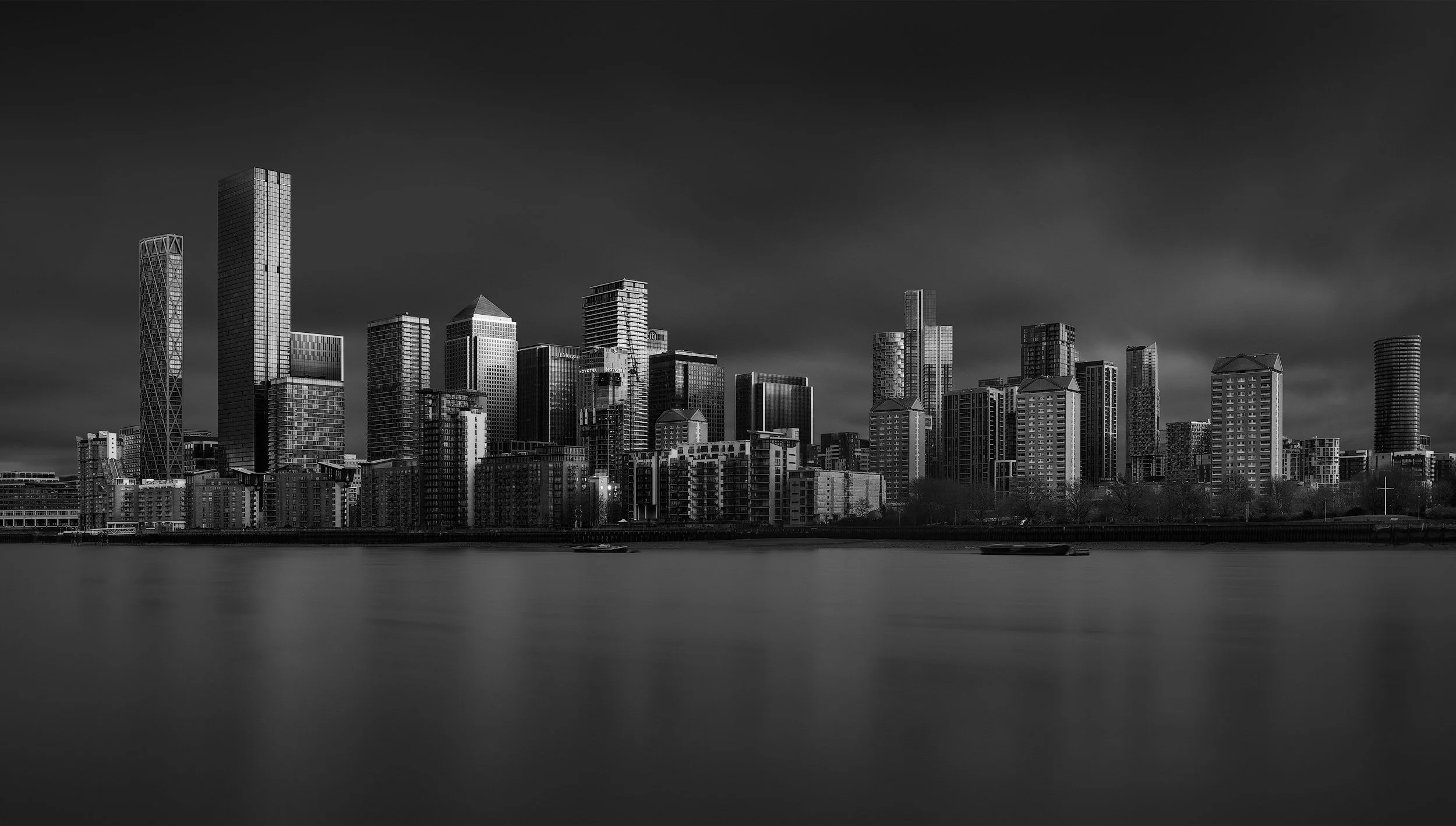 Black and white long exposure of the London Canary Wharf skyline, fine art architectural photography by Jim Scott.