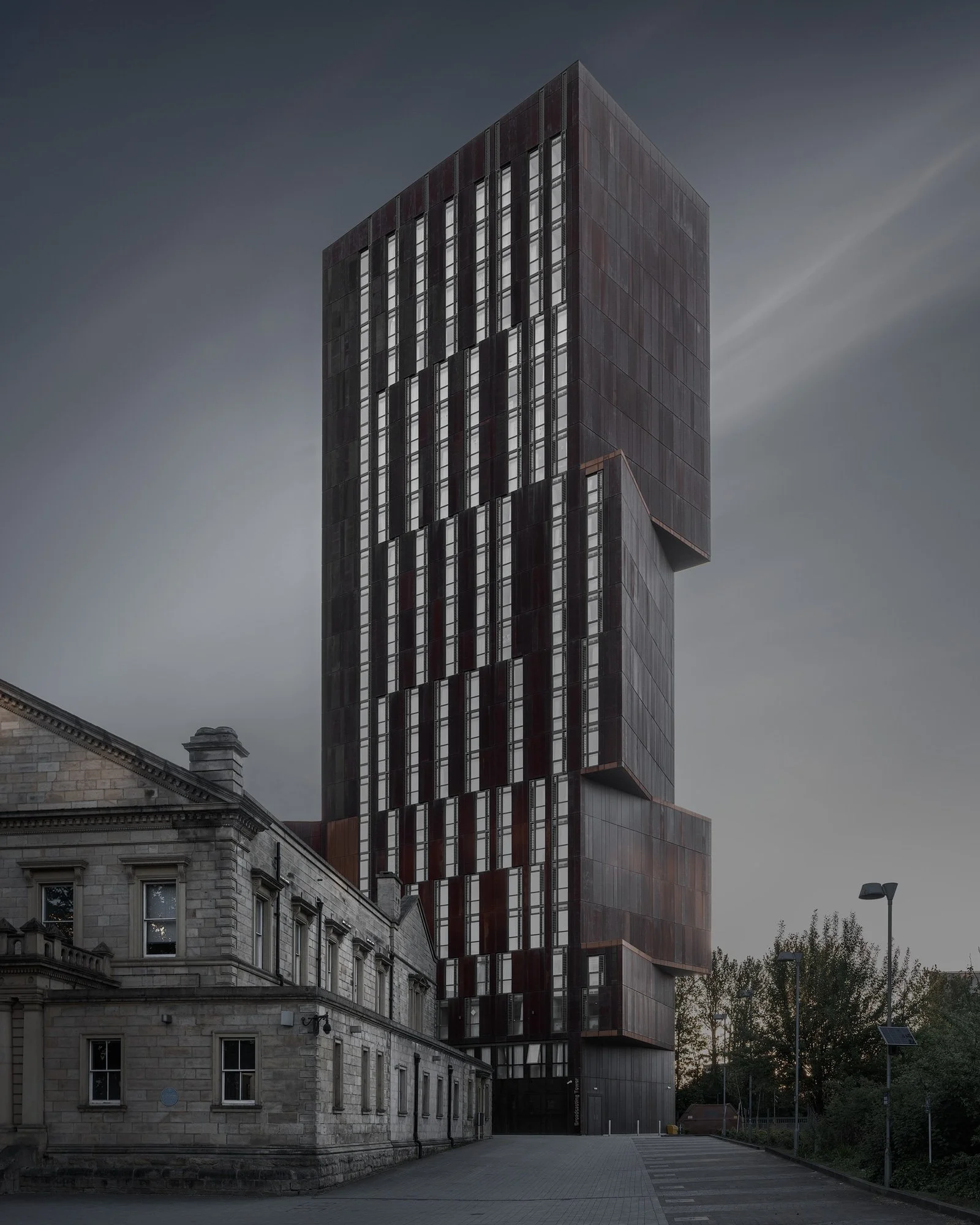 [architecture] [colour] [uk] [leeds] Colour long-exposure of Broadcasting Tower Leeds, Corten steel skyscraper beside Edwardian sandstone, Woodhouse Lane. Architectural Photography by Jim Scott.