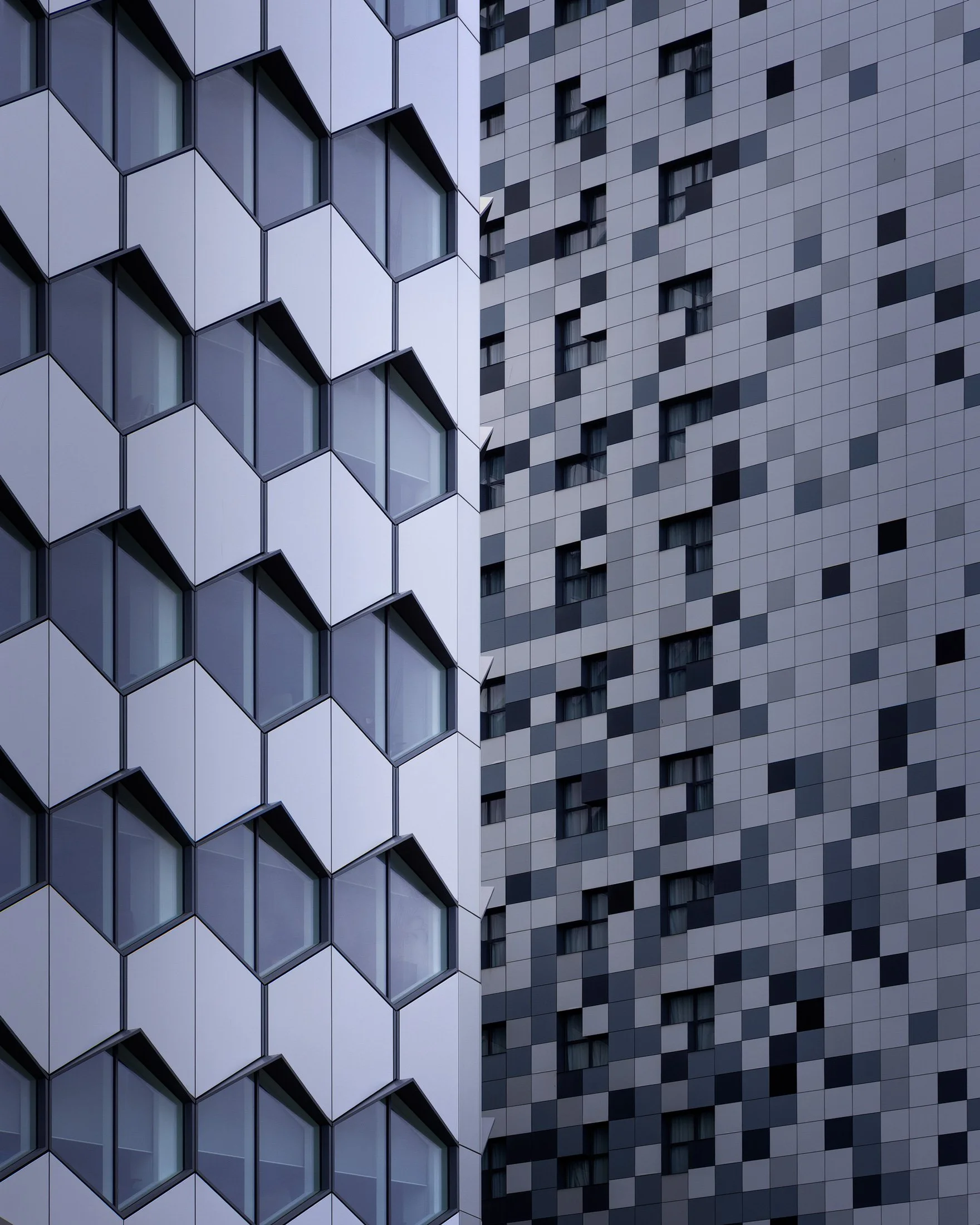 [architecture] [uk] [birmingham] [colour] [square] [abstract] Holiday Inn Express Birmingham, two contrasting facades — hexagonal white panels and a pixelated grey-blue tile pattern. Architectural Photography by Jim Scott.
