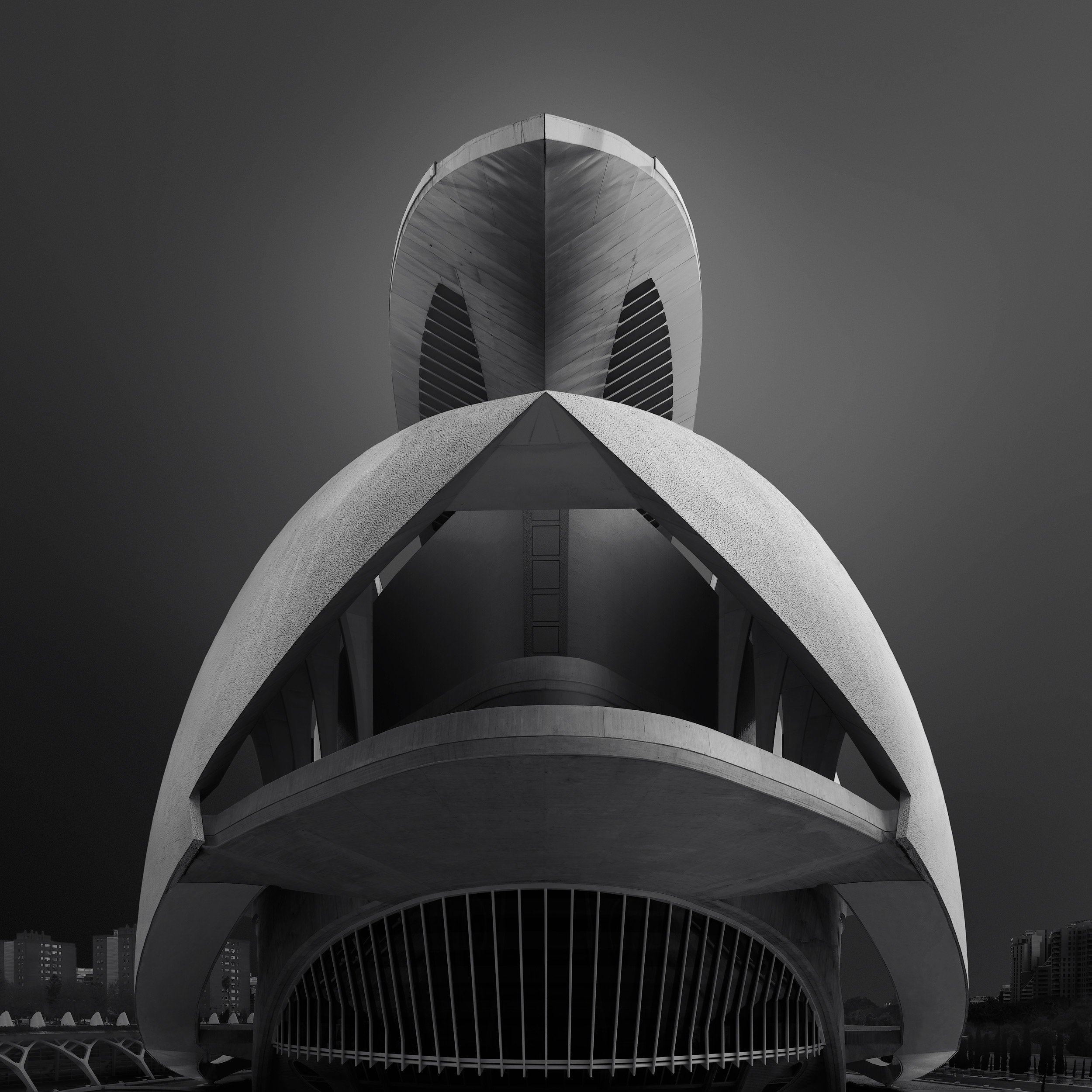 [architecture] [europe] [valencia] [blackandwhite] [square] Palau de les Arts Valencia frontal monochrome, Calatrava's stacked white shell crown and open arched entrance. Architectural Photography by Jim Scott.