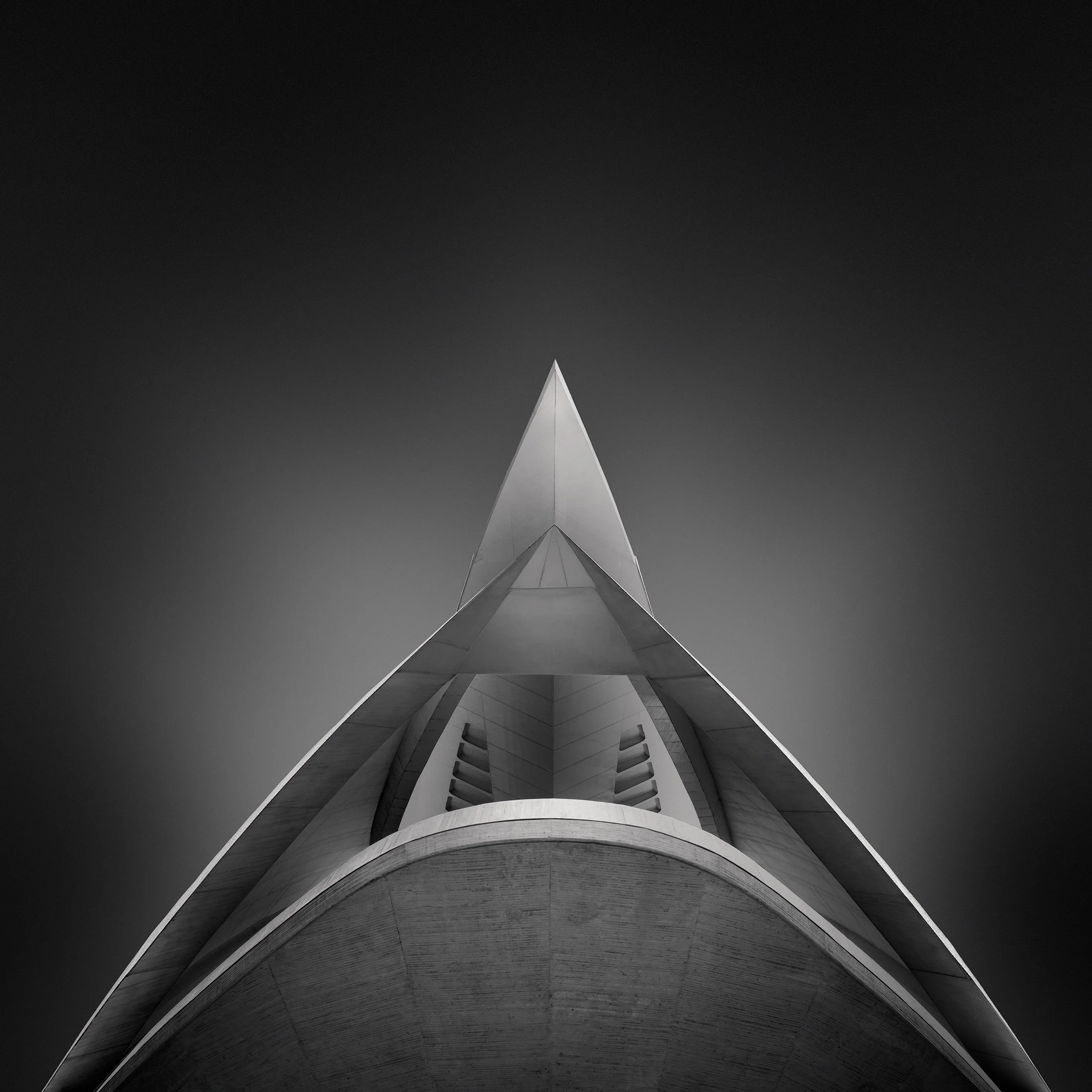 [architecture] [europe] [valencia] [blackandwhite] [square] Palau de les Arts Valencia abstract upward B&W, sharp concrete prow rising through curved white shell layers. Architectural Photography by Jim Scott.