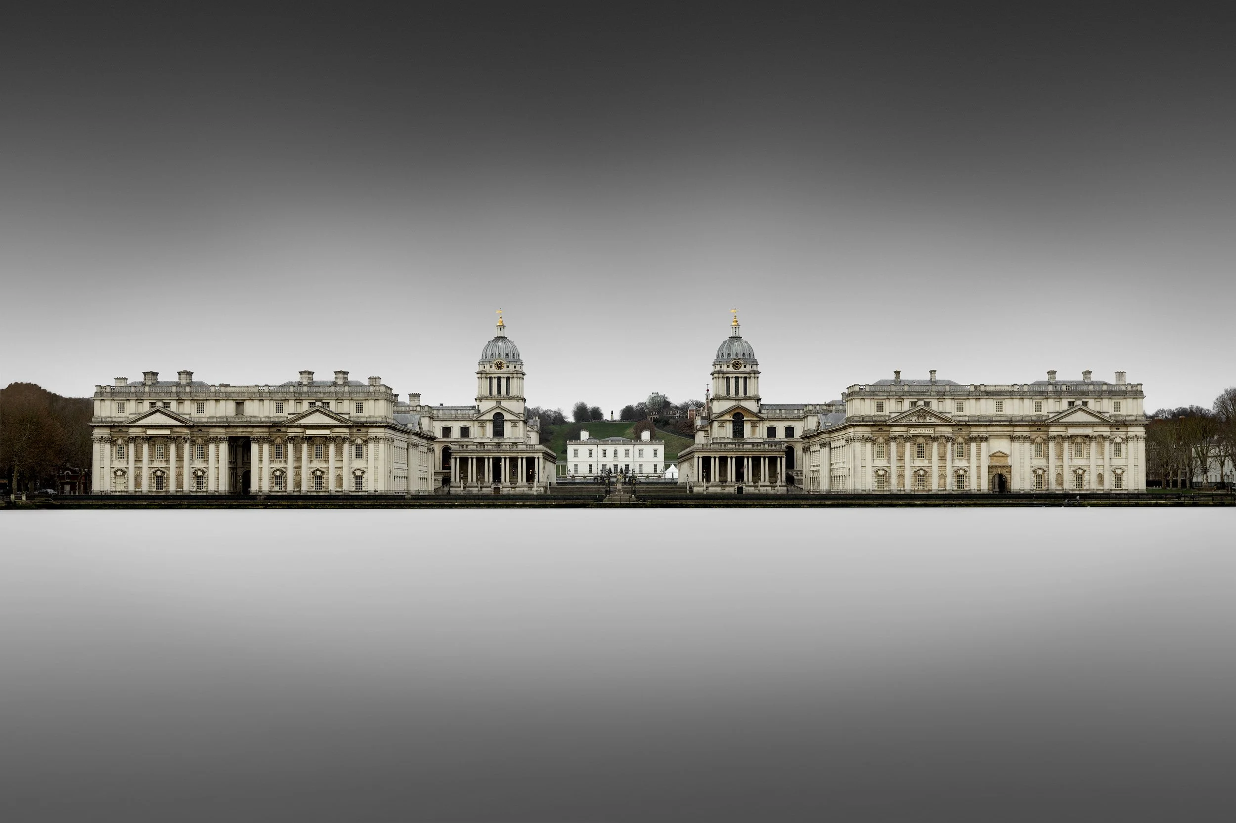 Historic baroque architecture in Greenwich, London: A dramatic study of the Old Royal Naval College, designed by Sir Christopher Wren. This architectural photograph captures the symmetrical grandeur of the King William and Queen Mary Courts, centred 