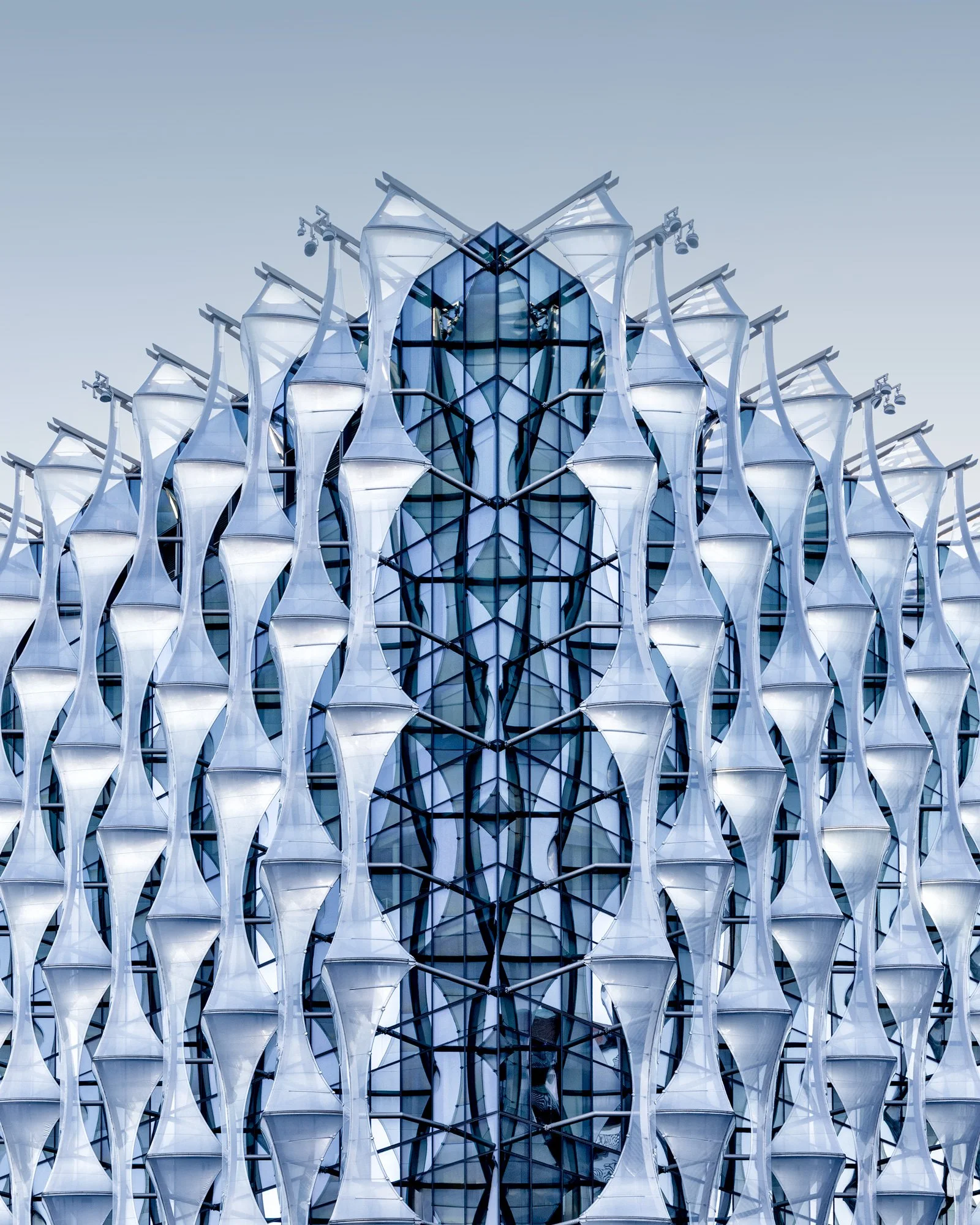 Symmetrical architectural study of the U.S. Embassy in London, designed by KieranTimberlake. This detailed photograph focuses on the building's innovative ETFE polymer facade, capturing the rhythmic, sail-like geometric patterns that wrap the glass s