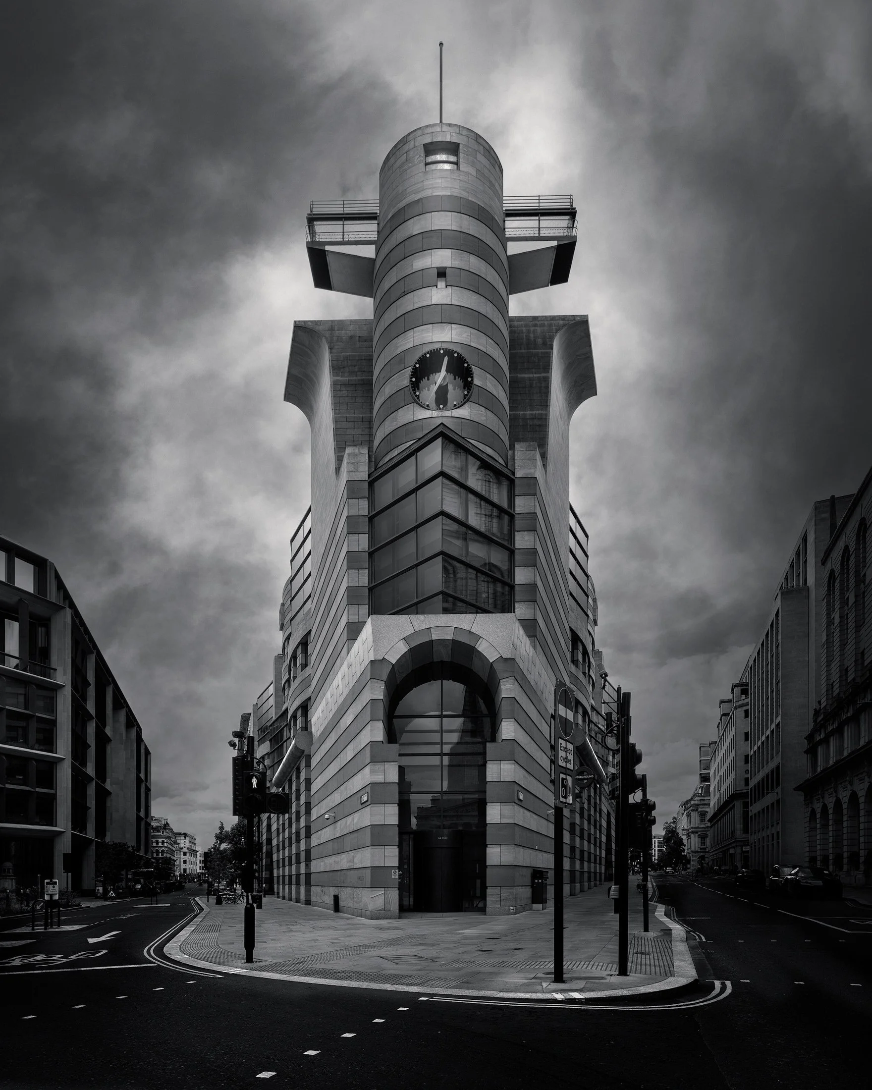 Postmodern architectural landmark in the City of London: A symmetrical monochrome study of No 1 Poultry, designed by James Stirling. This dramatic architectural photograph captures the building’s distinctive "prow" and clock tower, highlighting the r