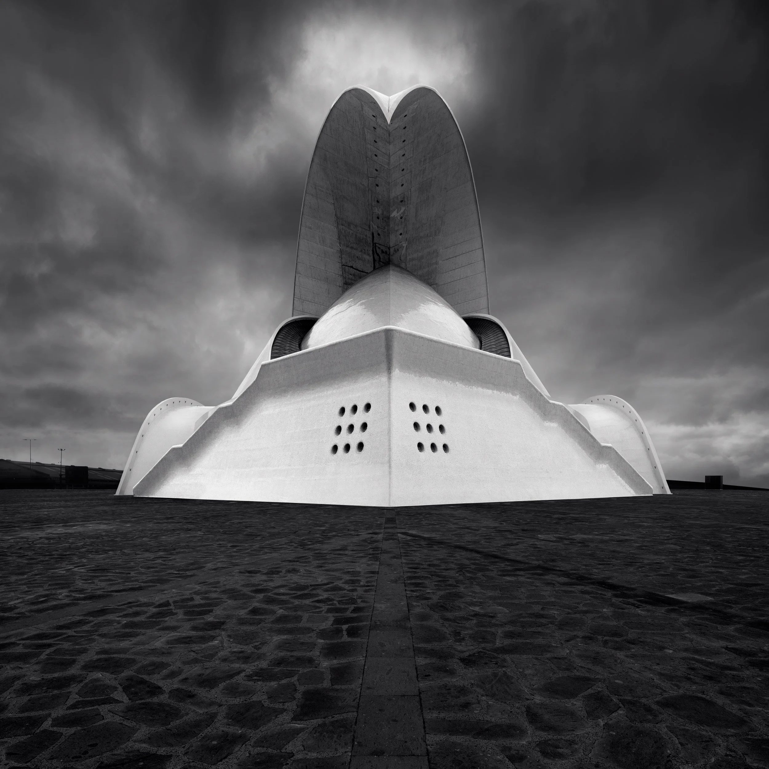Expressionist landmark architecture in Santa Cruz de Tenerife: A powerful monochromatic study of the Auditorio de Tenerife, designed by Santiago Calatrava. This symmetrical architectural photograph captures the building’s iconic sweeping concrete win