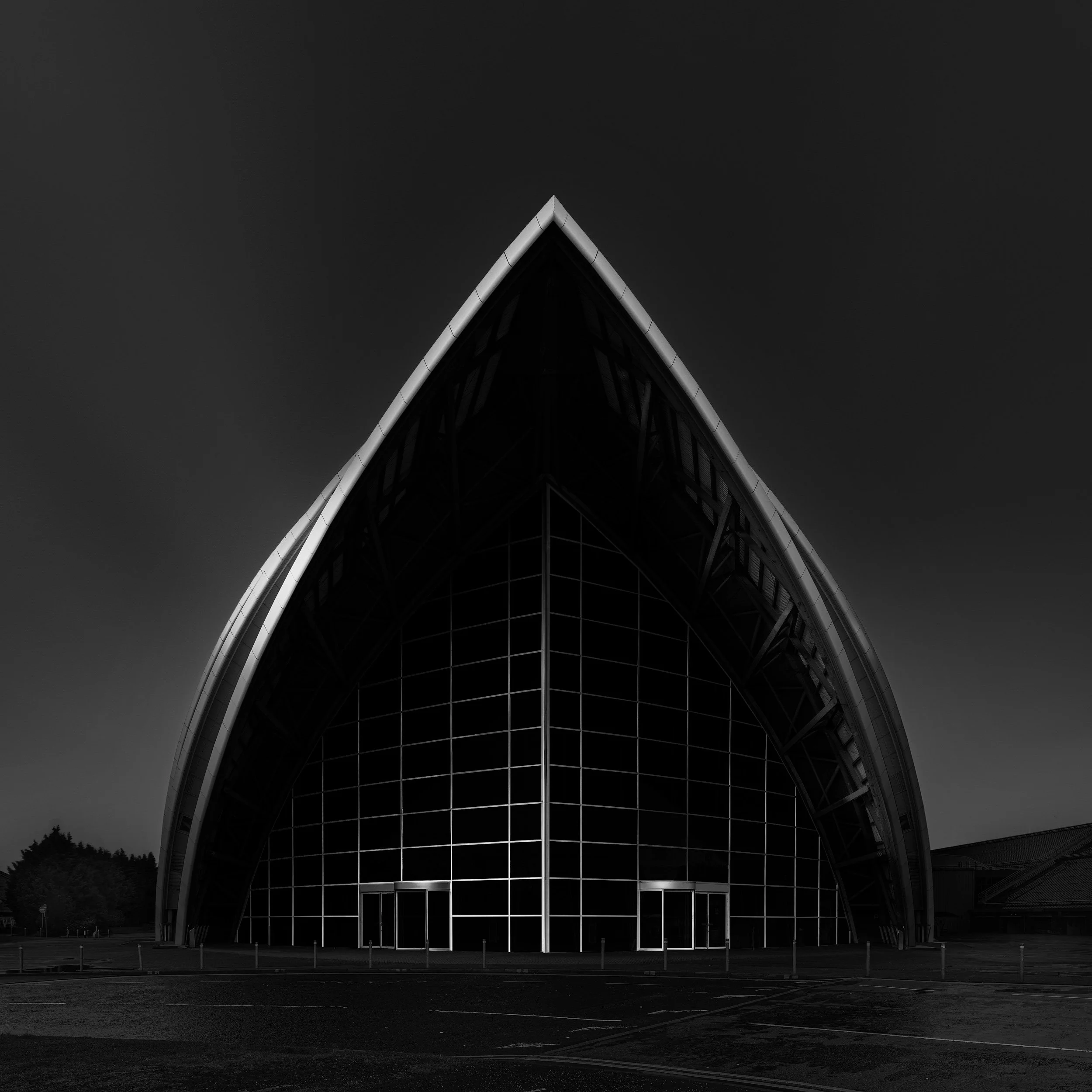 [architecture] [uk] [glasgow] [blackandwhite] [square] Clyde Auditorium Glasgow head-on monochrome, single pointed stainless steel shell form rising symmetrically. Architectural Photography by Jim Scott.