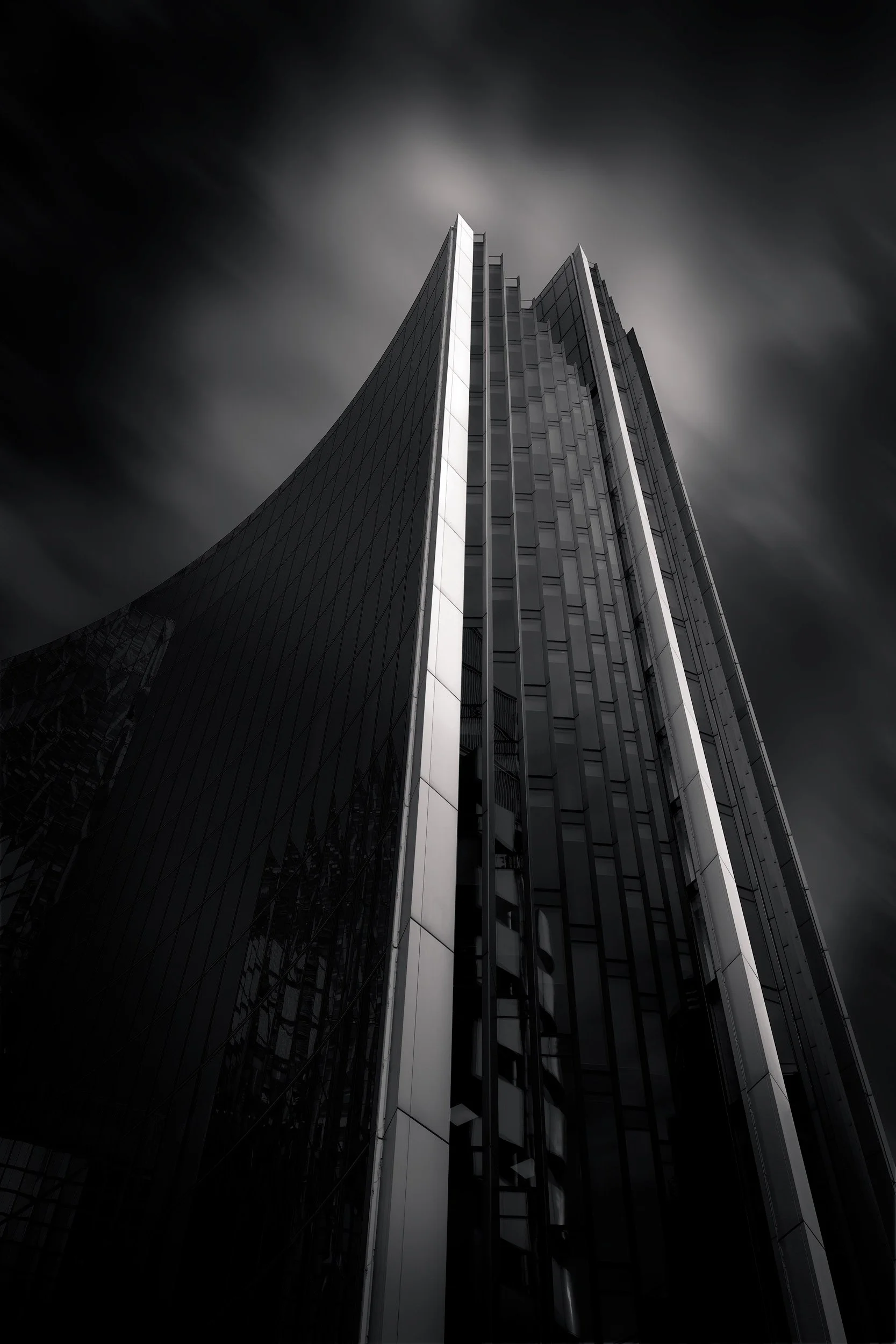 [architecture] [uk] [london] [blackandwhite] Leadenhall Building and The Scalpel London City cluster, looking up between converging glass towers, vertiginous black and white. Architectural Photography by Jim Scott.