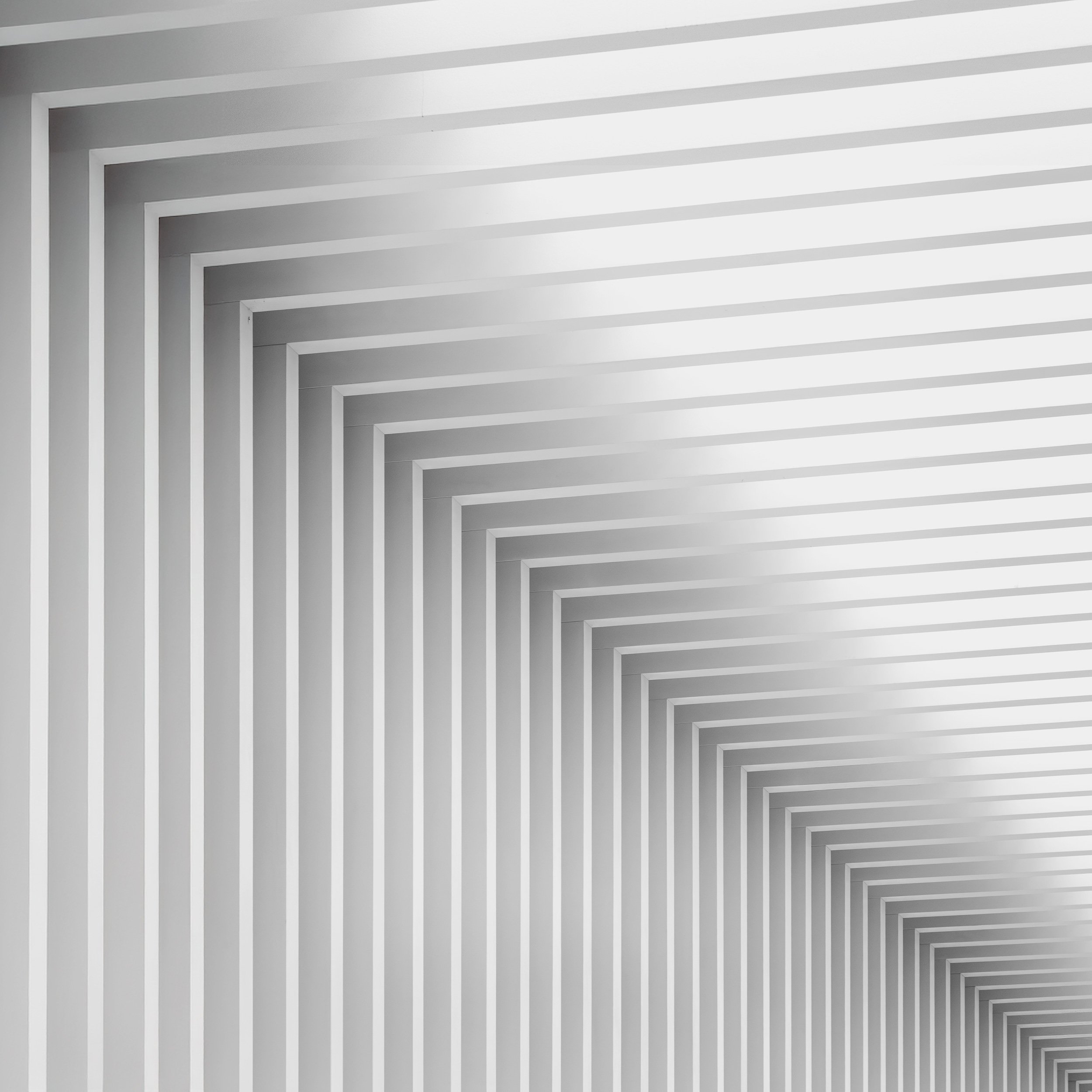 [architecture] [uk] [birmingham] [blackandwhite] [square] [abstract] Mailbox Birmingham facade pure abstract, infinite receding white chevron mouldings in tonal gradients. Architectural Photography by Jim Scott.