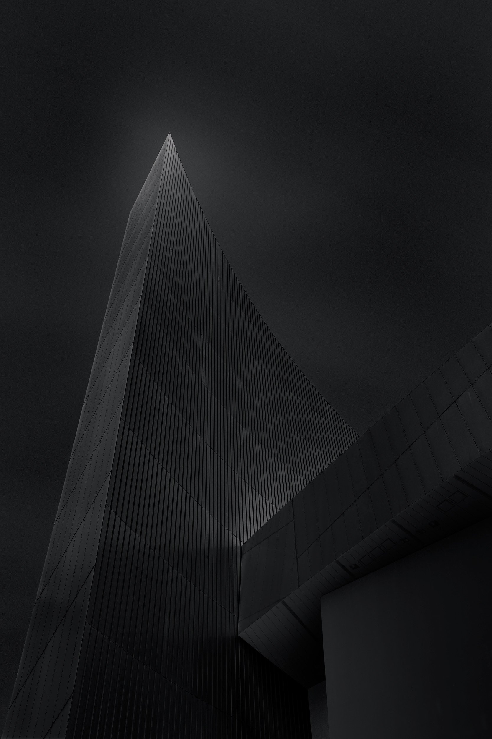 [architecture] [uk] [salford] [blackandwhite] [square] IWM North Salford, Libeskind's dark corrugated steel triangular shard rising sharply against an ink-black stormy sky. Architectural Photography by Jim Scott.