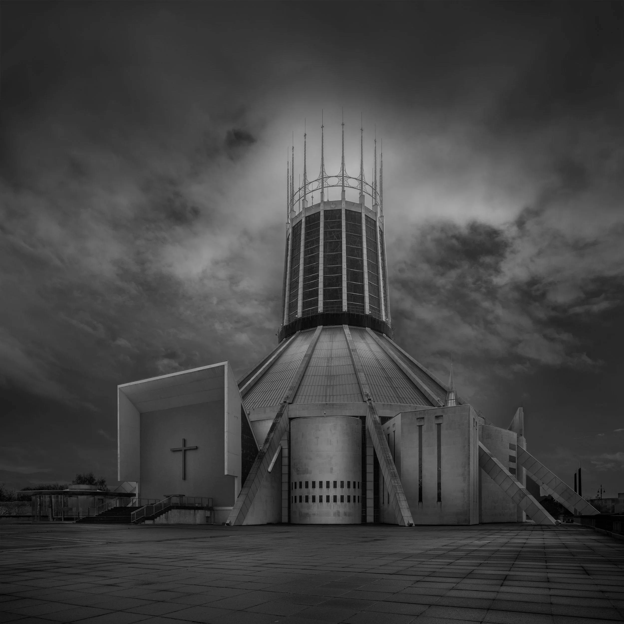 [architecture] [uk] [liverpool] [blackandwhite] [square] Liverpool Metropolitan Cathedral, bold concrete lantern tower with steel pinnacles rising from the stepped plaza. Architectural Photography by Jim Scott.