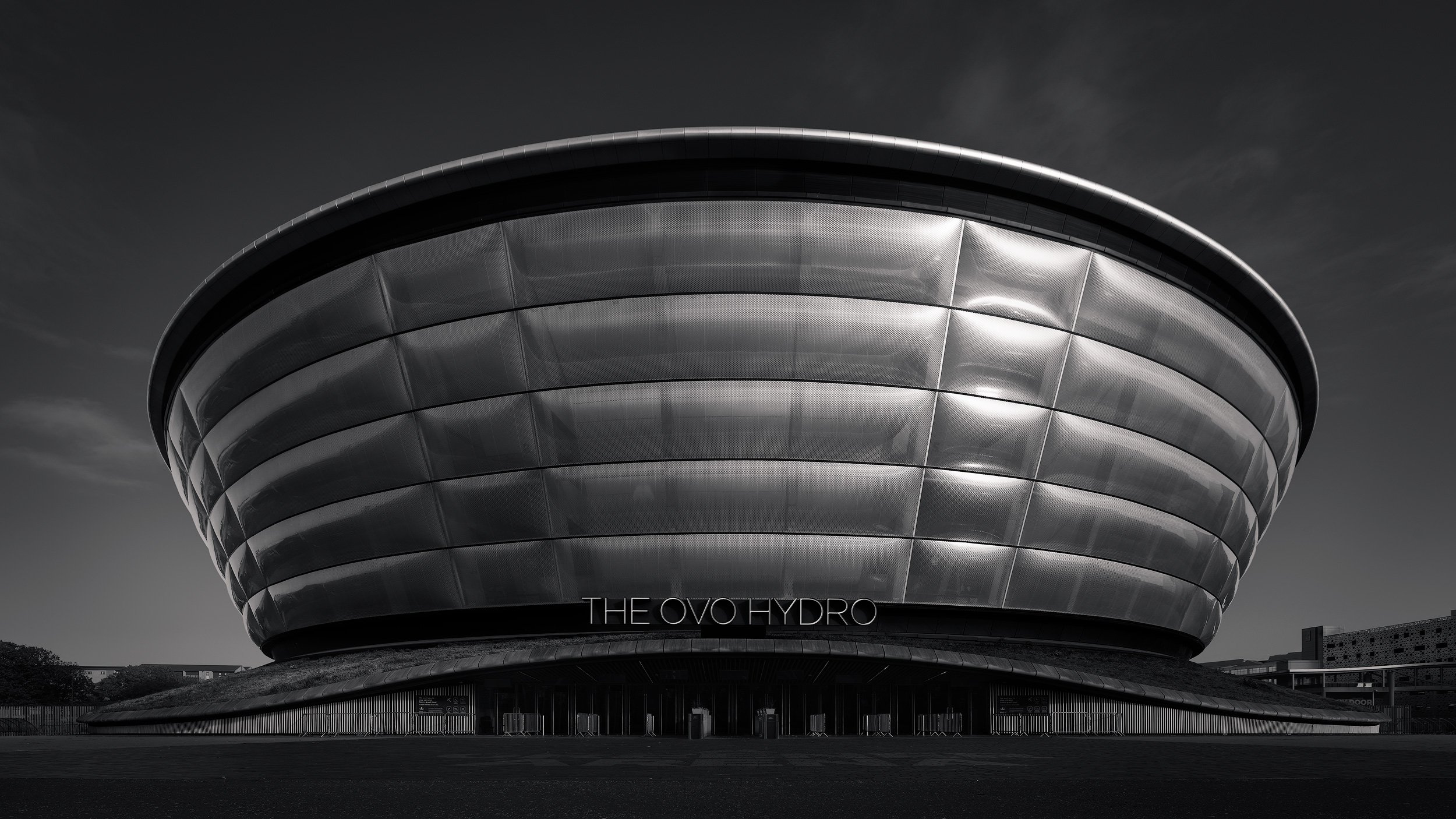 [architecture] [uk] [glasgow] [blackandwhite] OVO Hydro Glasgow arena, iconic ribbed curved metallic dome facade, bold black and white architectural monochrome. Architectural Photography by Jim Scott.