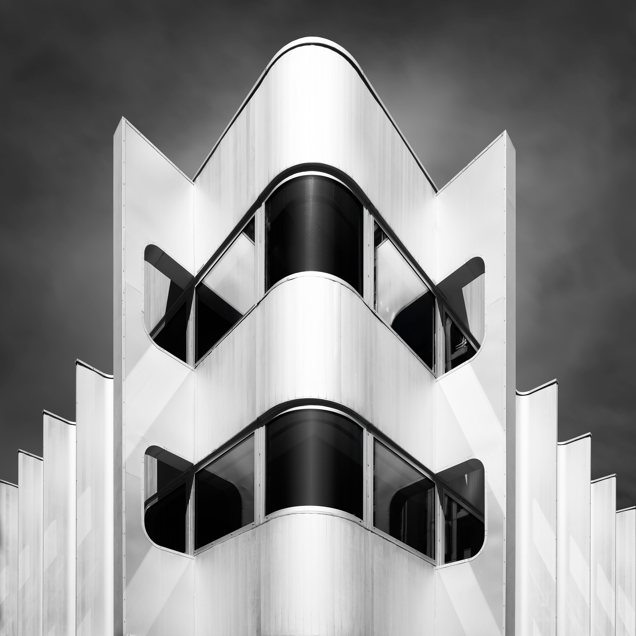 [architecture] [europe] [paris] [blackandwhite] [square] Beaugrenelle Paris, sculptural wave-form white aluminium fins and curved dark glazed cylinders in bold contrast. Architectural Photography by Jim Scott.