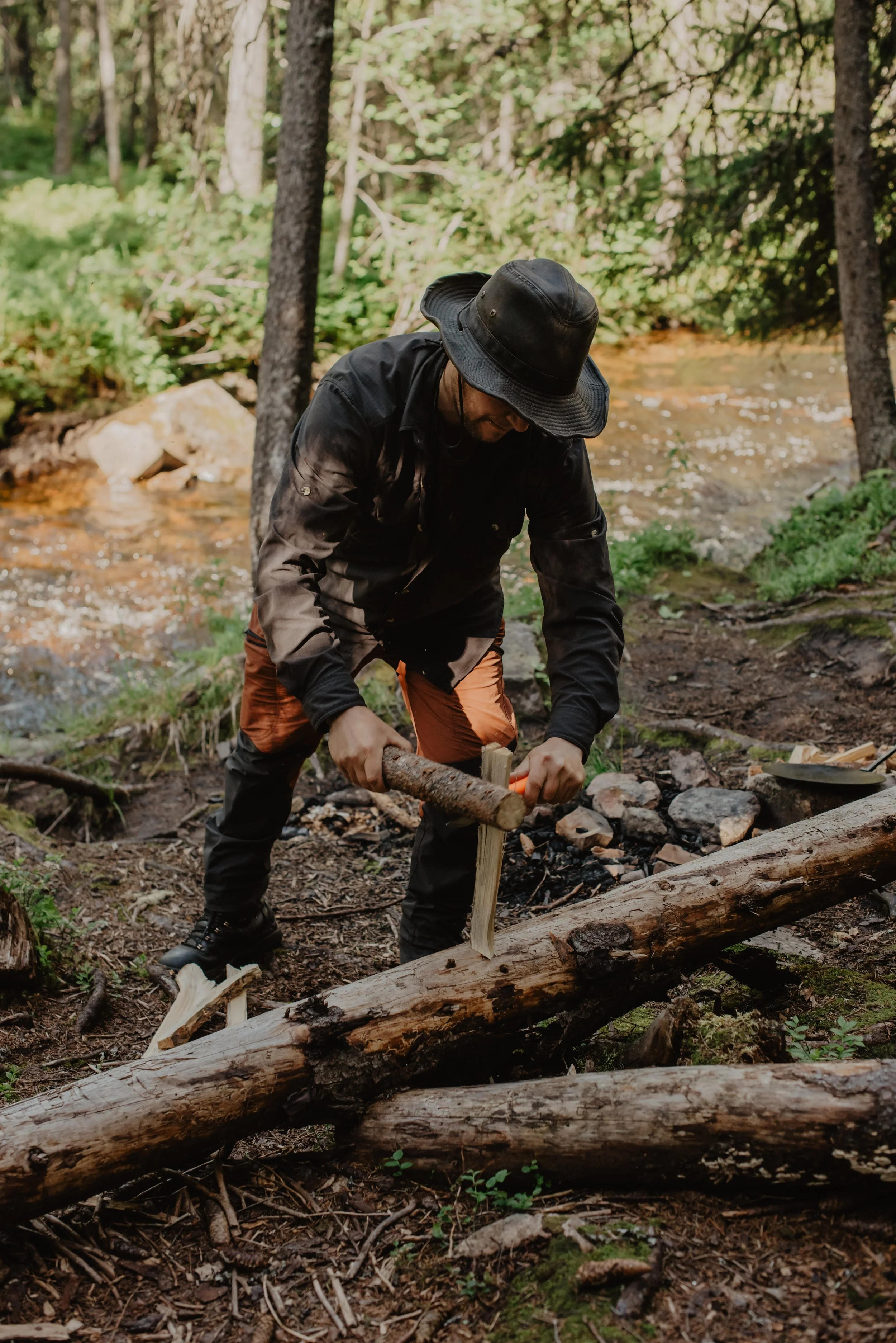 Guide teaches guests how to make a fire at waterfall in dalarna