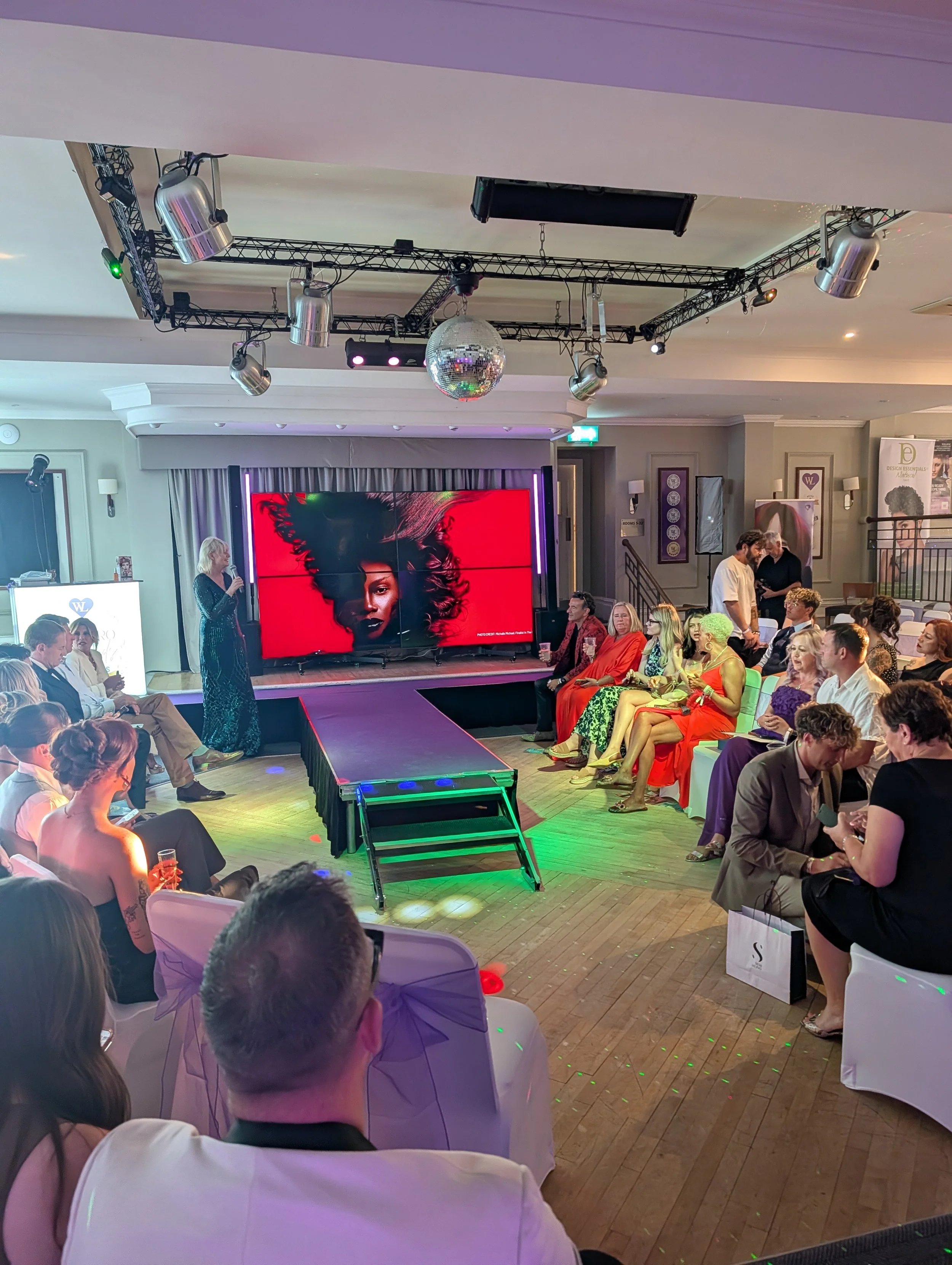 Catwalk and stage extension carpeted to suit the event branding.
