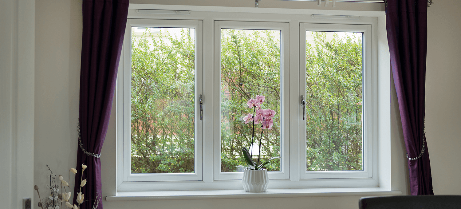Flush frame UPVC window closed with flower in window white stylish window