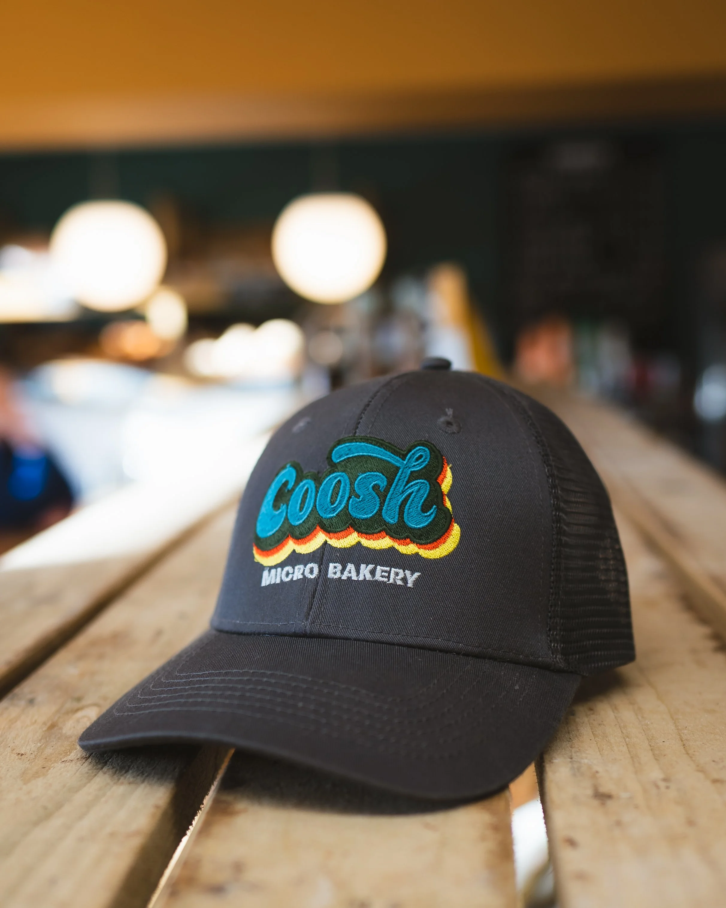 Logo design for bakery on cap with bakery in background