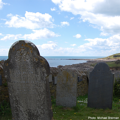 Old Tombstones facing sea shore - by Michael Brennan