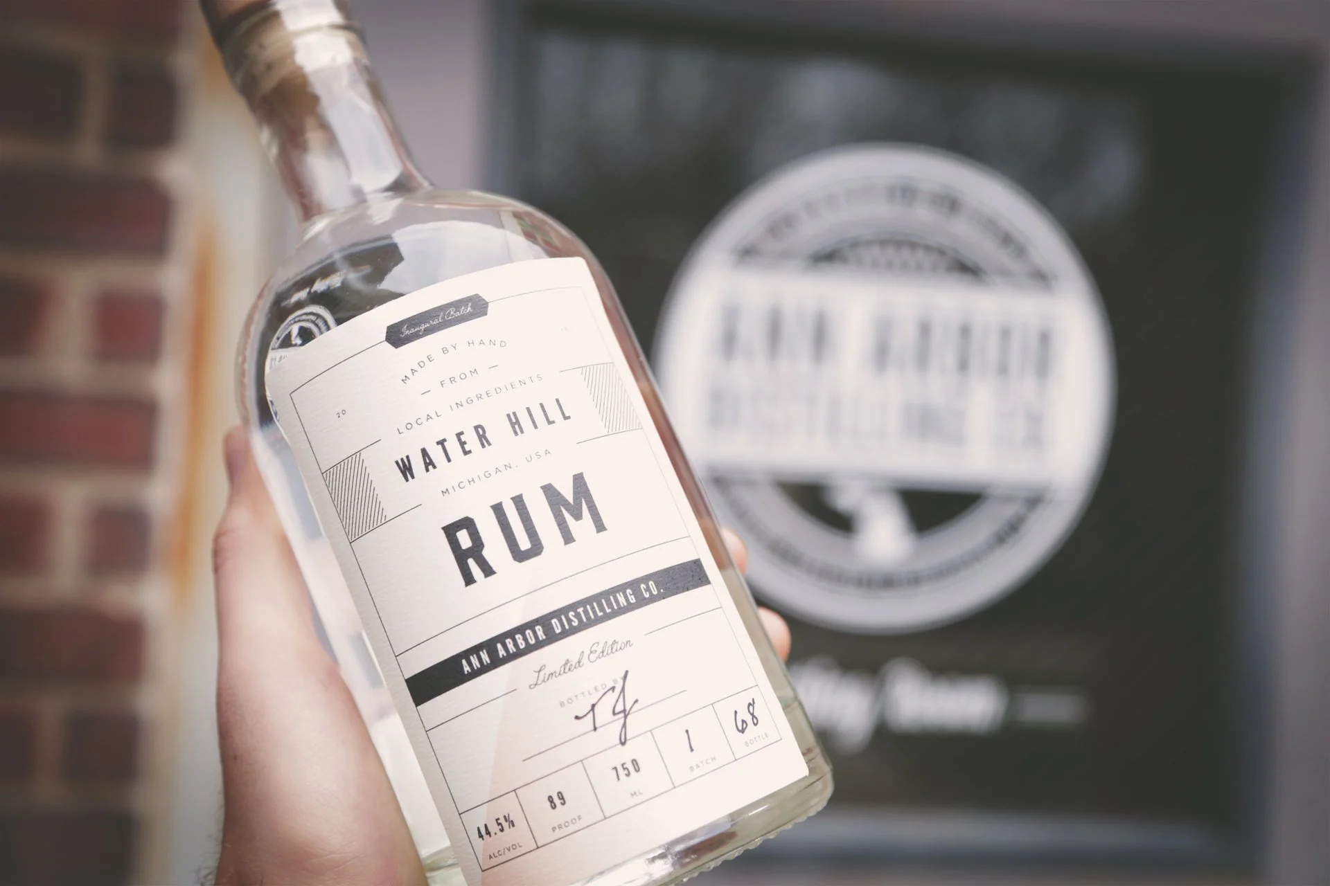 Hand holding a bottle of Water Hill Rum from Ann Arbor Distilling Co.