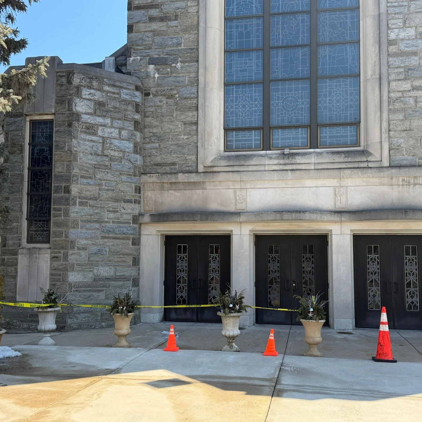 TRIPPING HAZARD
Due to the freezing and thawing, the concrete in the front of the church is lifiting and could be a tripping hazard. We have arranged cones and planters to deter people from walking around it. Once the ground finishes thawing, it shou