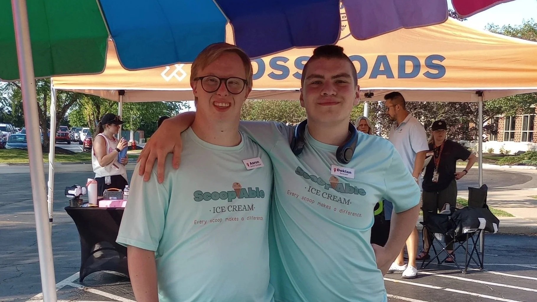 Two employees from ScoopAble hosting a catering event.
