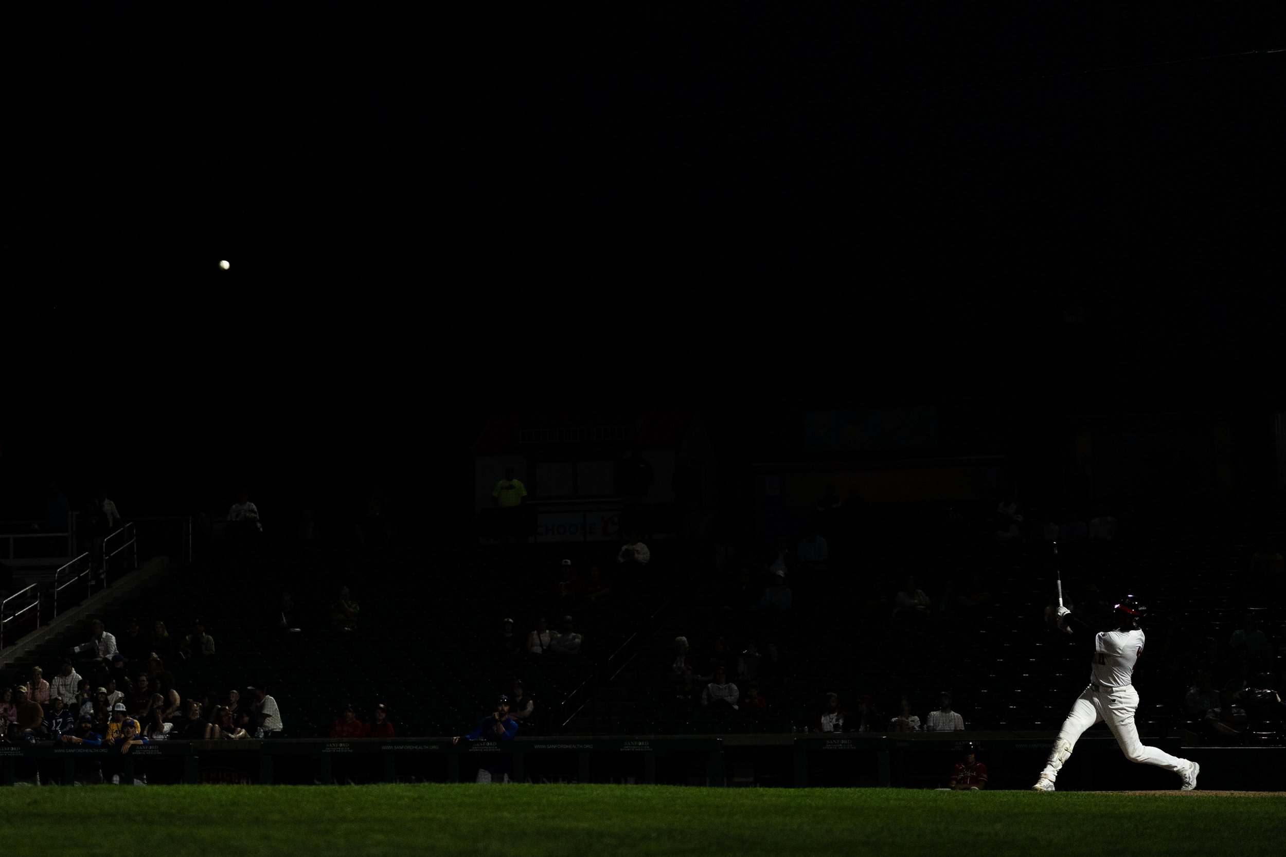 Fargo-Moorhead RedHawks infielder Jose Sermo hits a deep fly ball into the night during game two against the Sioux Falls Canaries at Newman Outdoor Field in Fargo, ND, on August 15th, 2026.