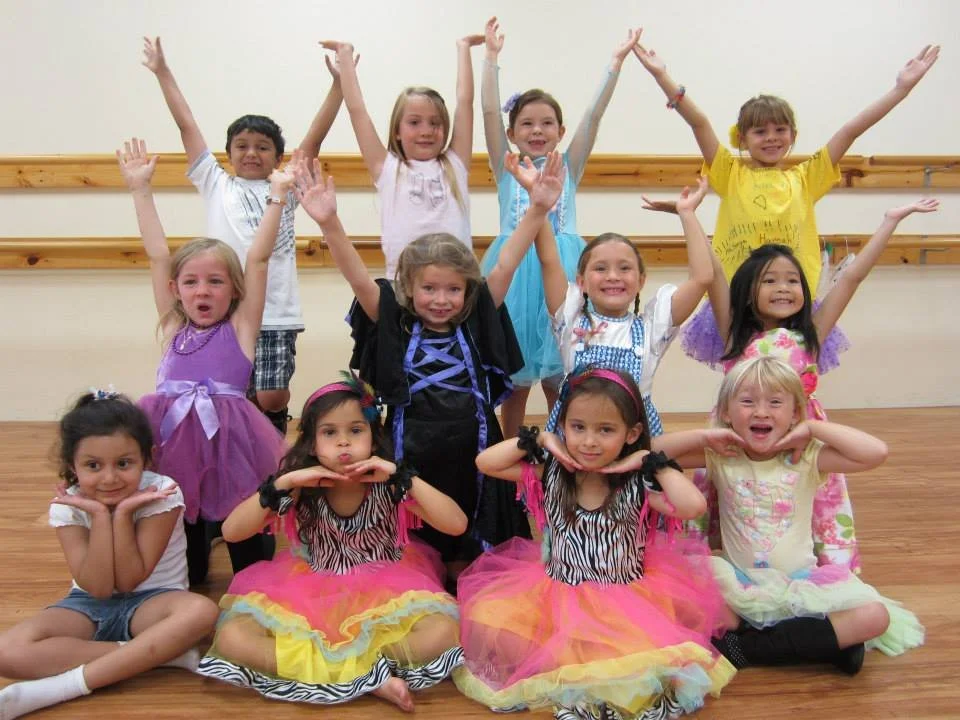 Students posing in costumes at a theater in Orange County, smiles, having fun, learning theatre