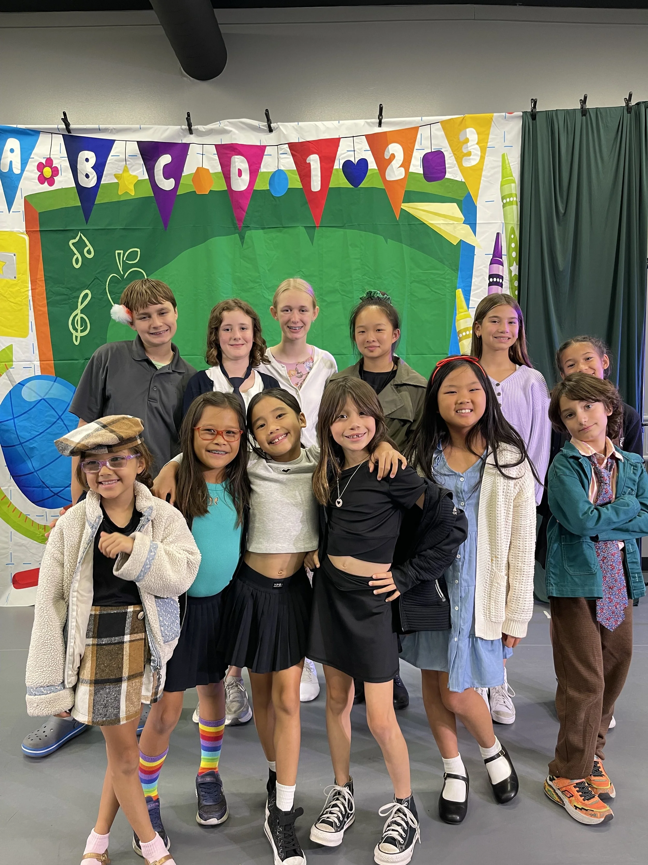 Older students posing for a group photo in Torrance after performing a play