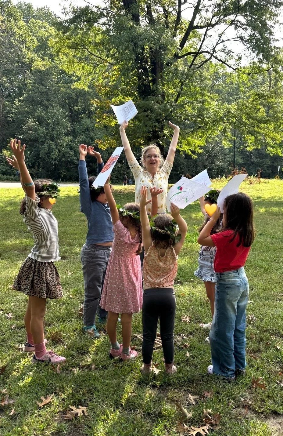 Green Magic kids acting out growing from a tiny seed into a big strong tree with teacher, Catharine.