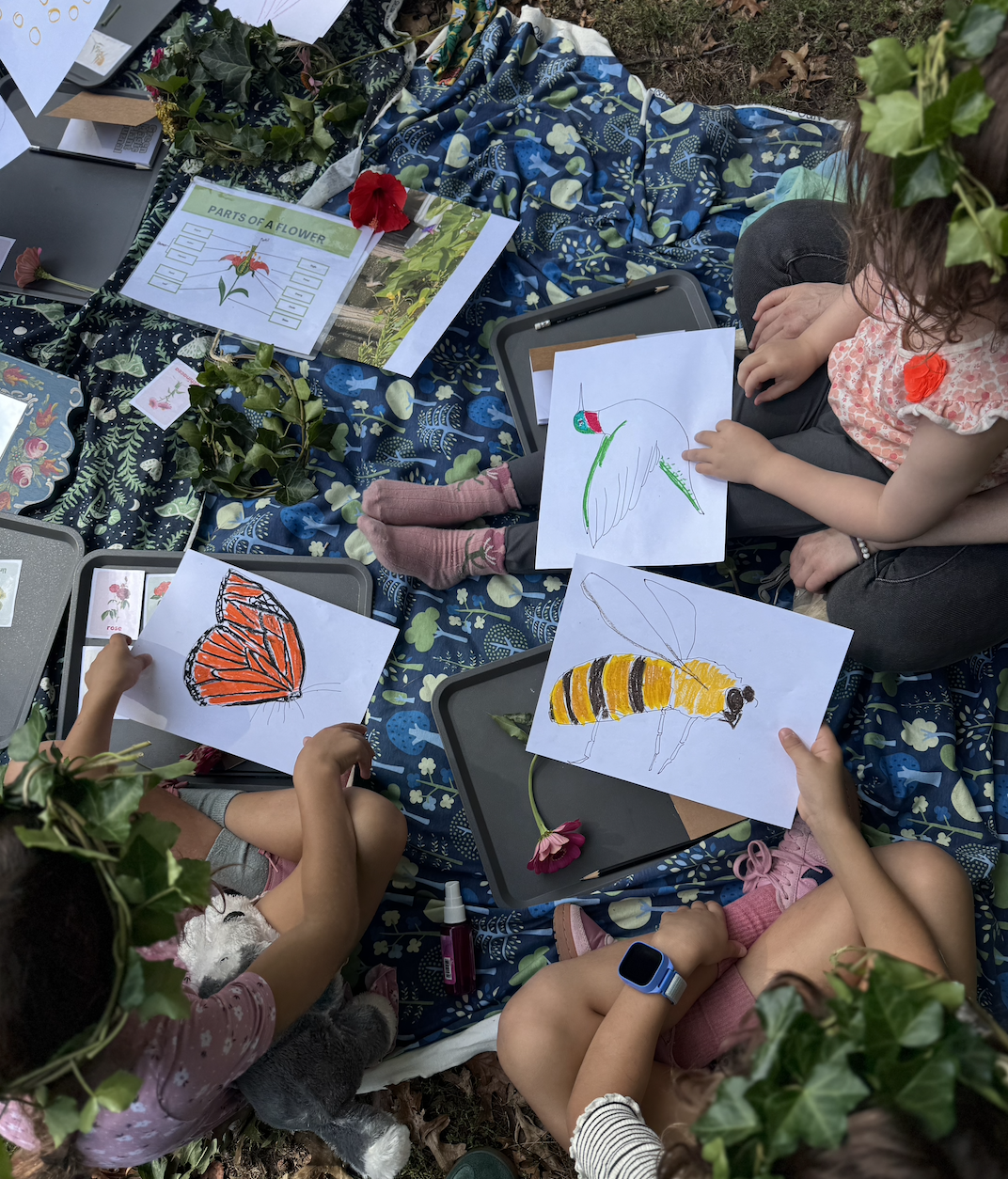 Green magic kids choosing which role to play when the group acts out pollination. 