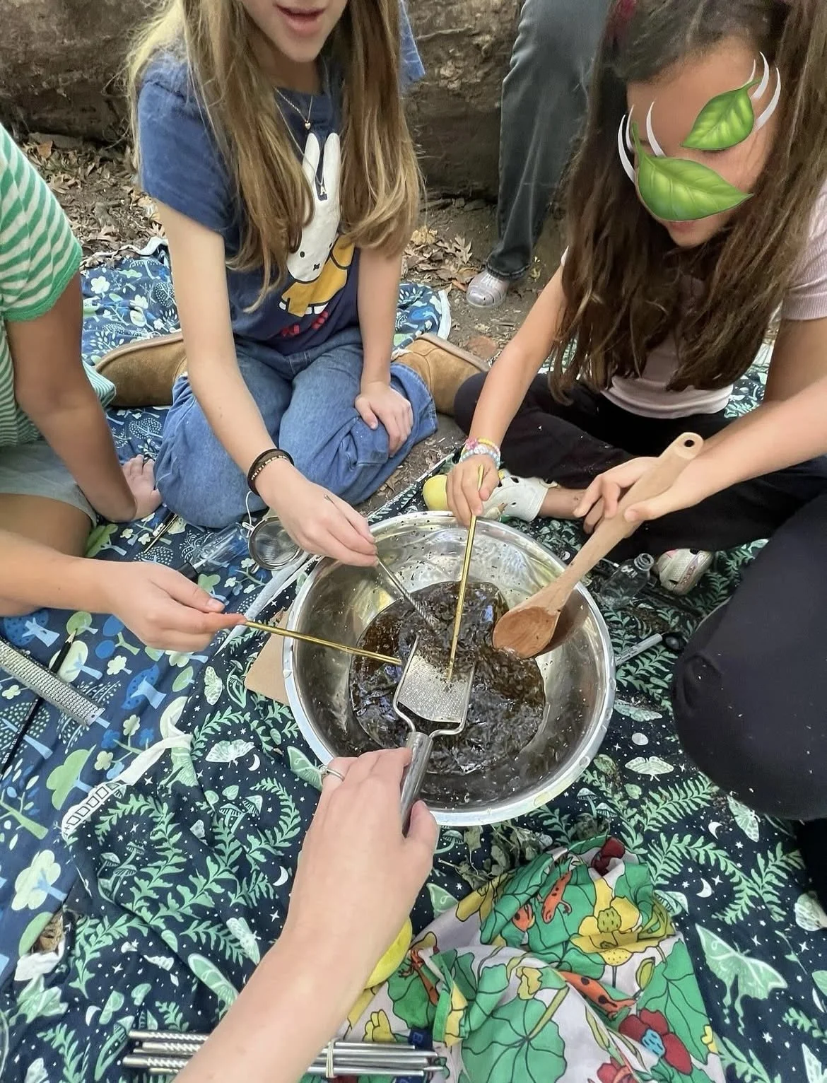 Green magic kids mixing their lemon balm herbal spray. 