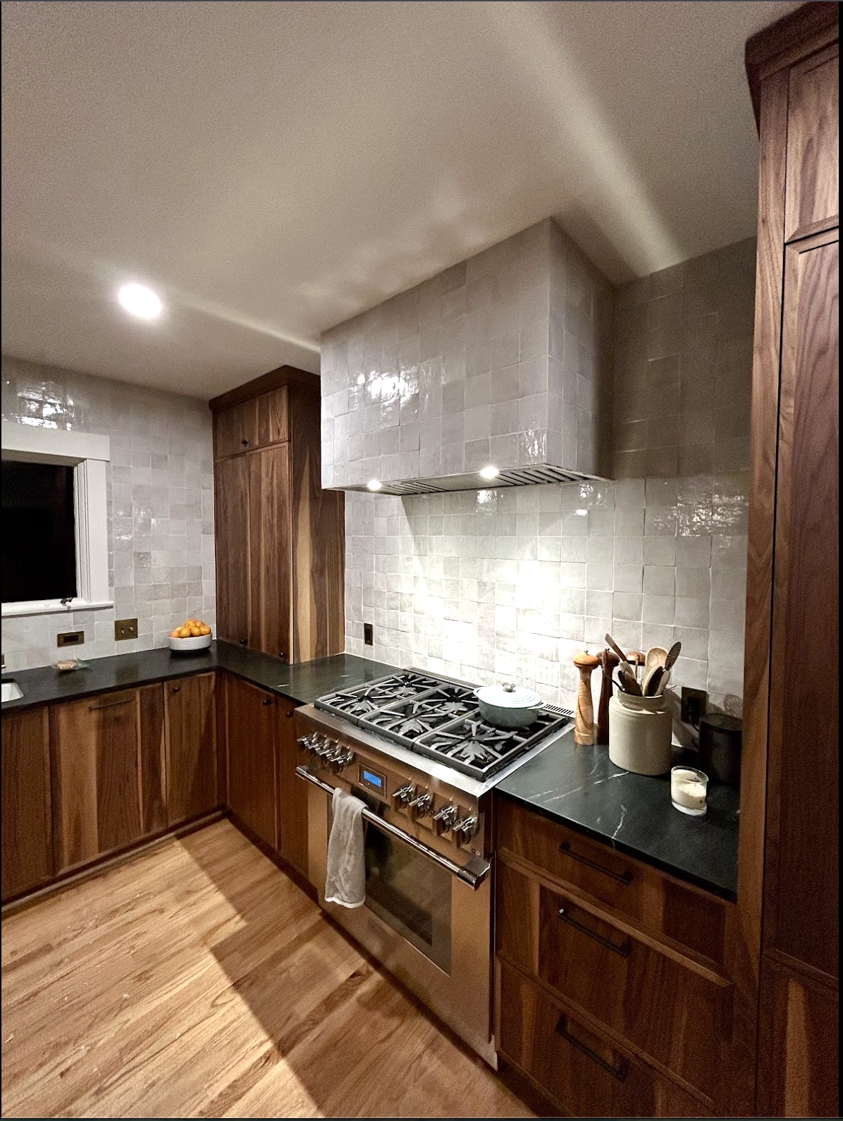 Full-height Zellige kitchen tile installation in Durham, NC with glossy backsplash tile, custom range hood surround, warm wood cabinets, dark countertops, and precision layout by Parker’s Precision Tile.

File Name: