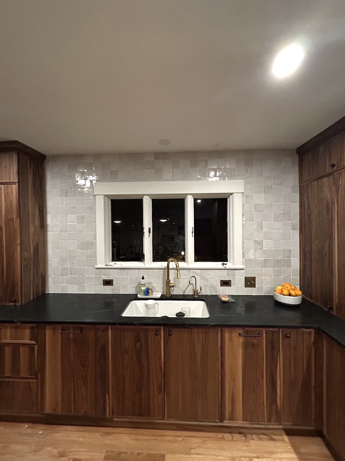 Zellige kitchen backsplash installation in Durham, NC featuring glossy square tile, full-height wall coverage, warm wood cabinetry, dark countertops, and precision tilework by Parker’s Precision Tile.