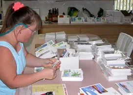 Cinnamon packaging her cards for an art show