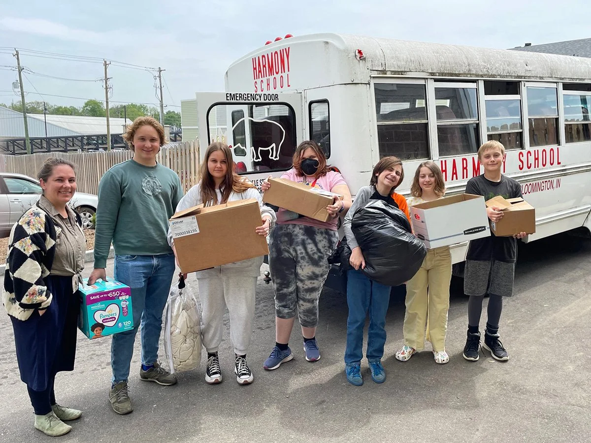 Students and staff from Harmony School deliver donations they collected to benefit New Hope for Families