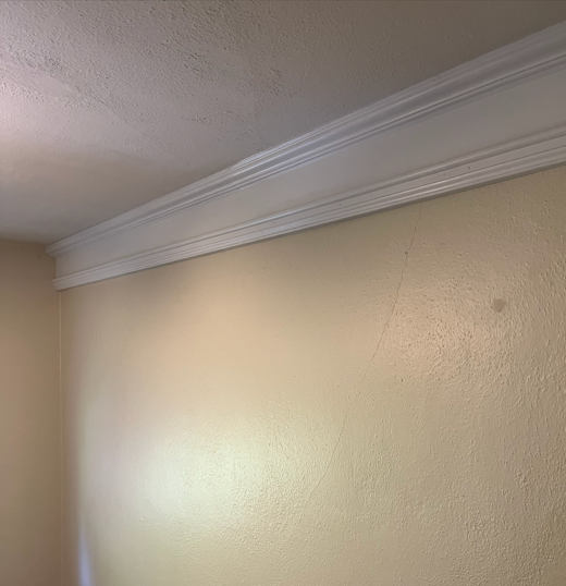 Custom crown molding with integrated picture rail in 1930 home.