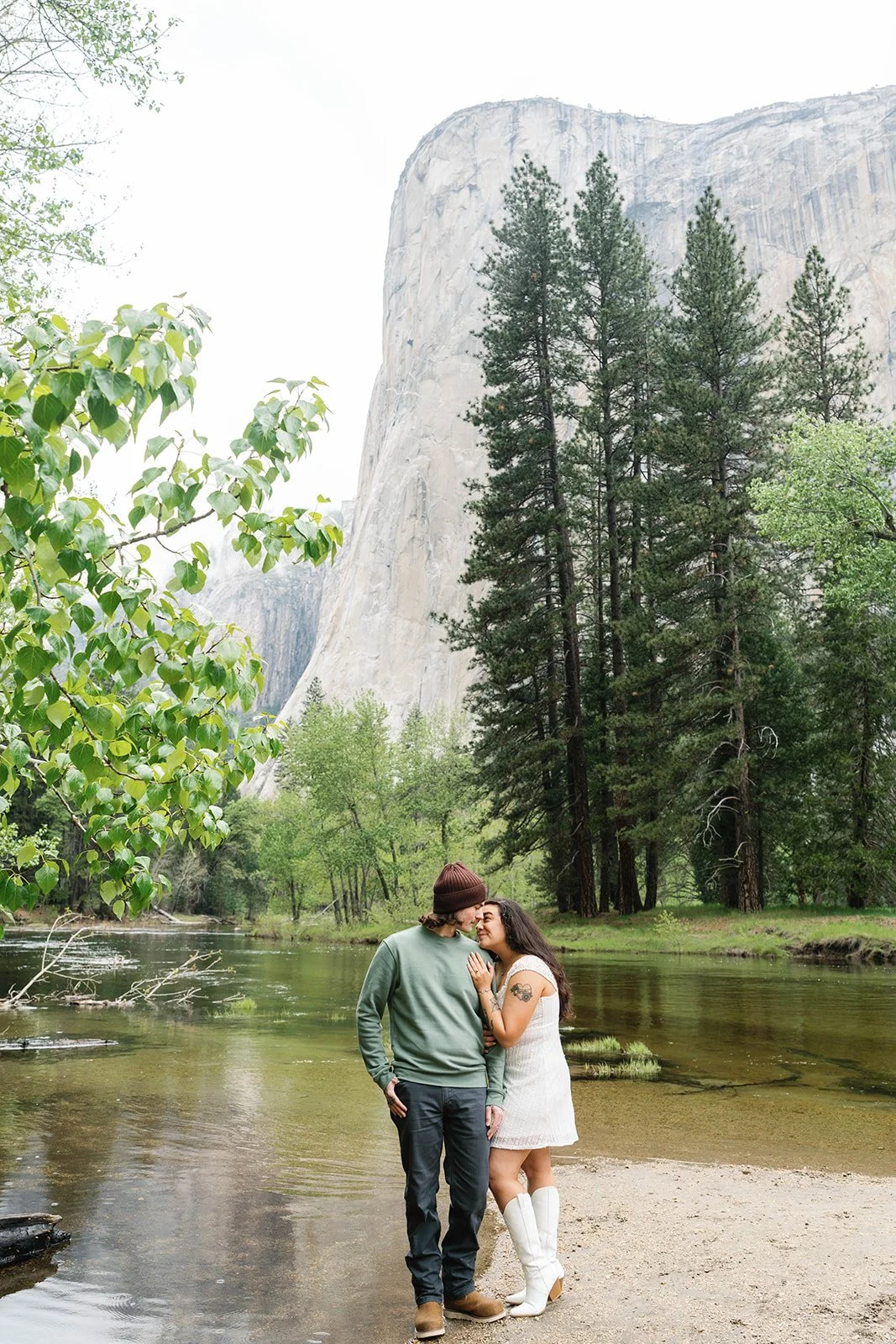 Man and woman hold hands during Cathedral Beach engagement pictures
