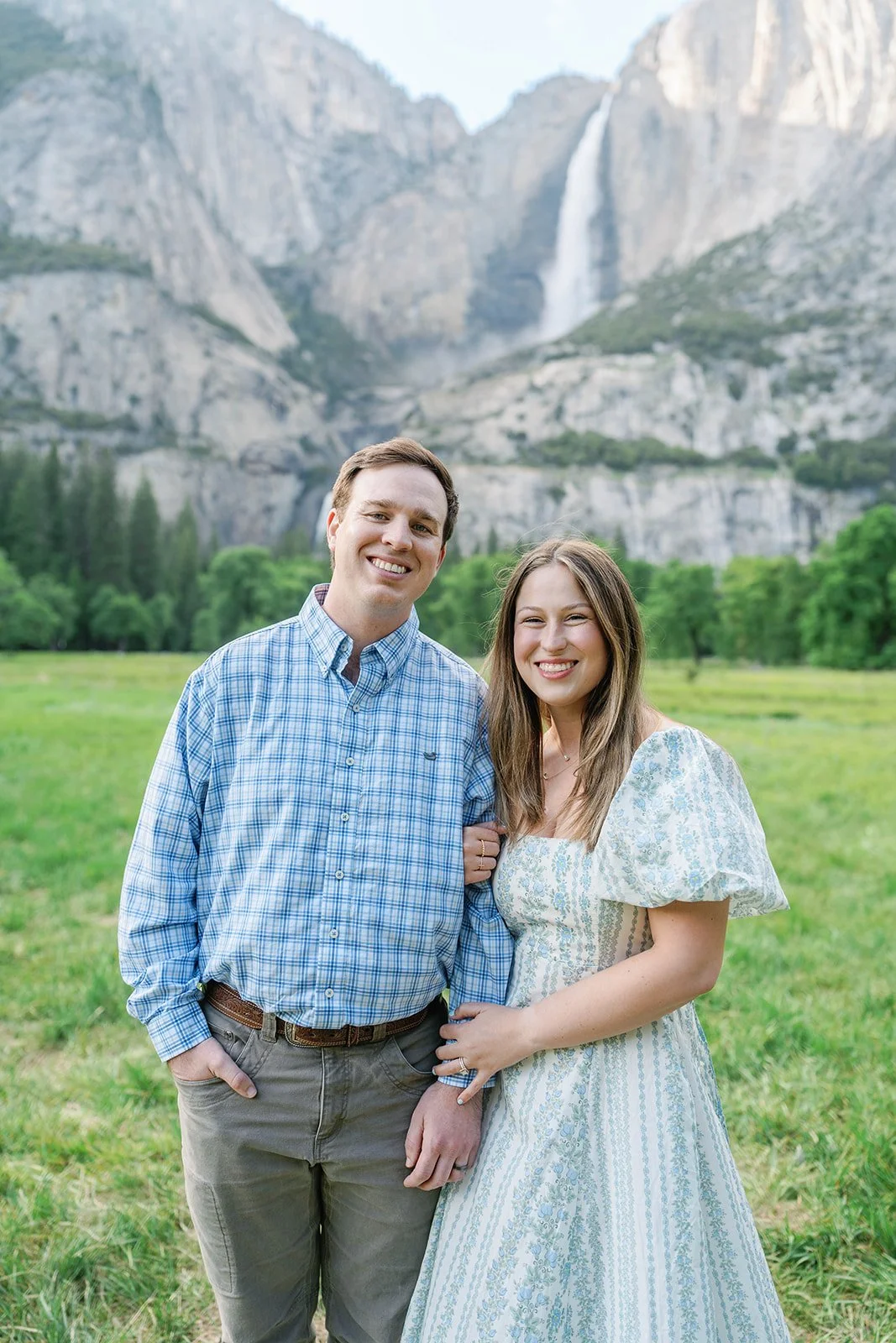 Man and woman smiling at the camera in El Capitan Meadow