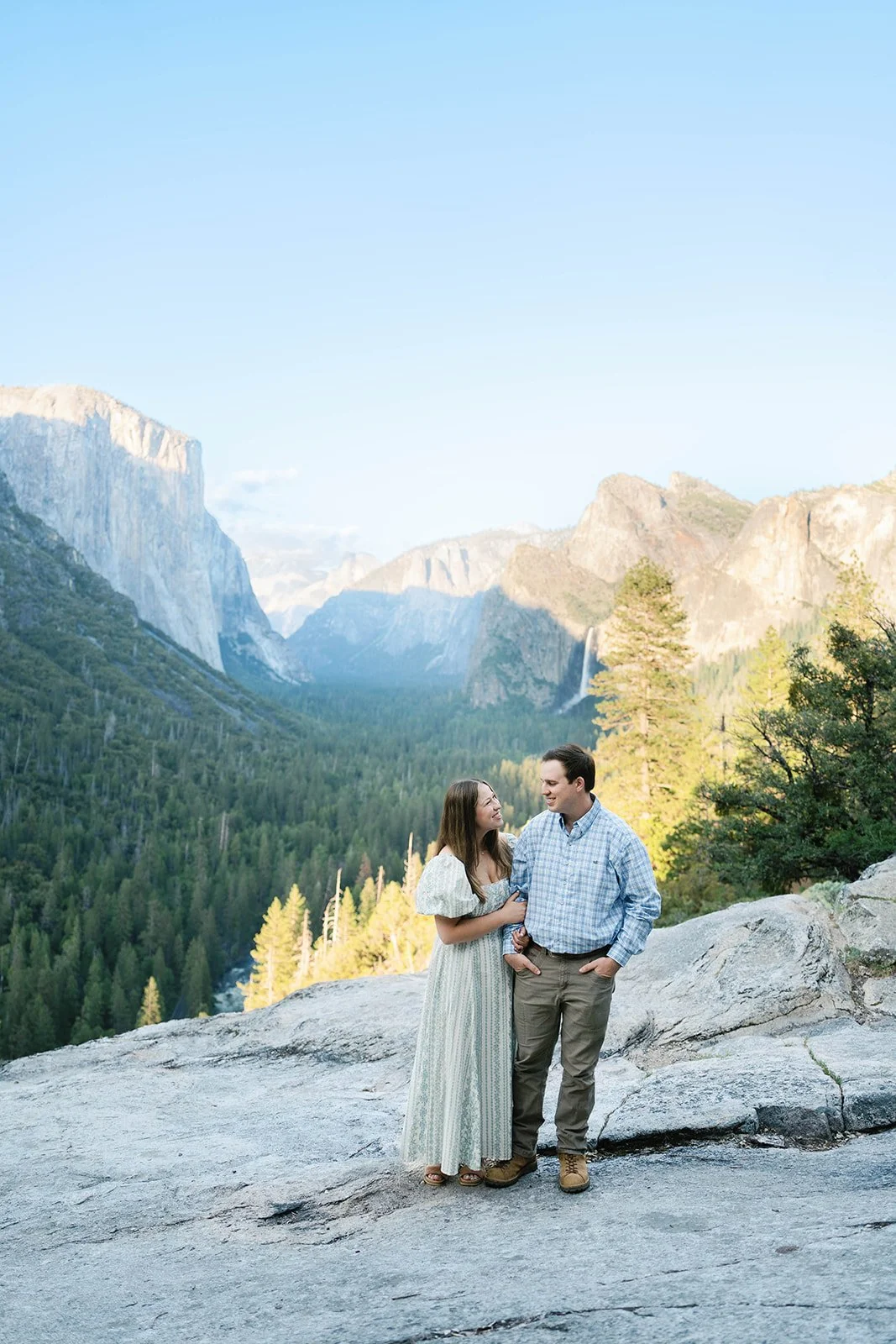 couple smiles at each other at Tunnel View in Yosemite National Park