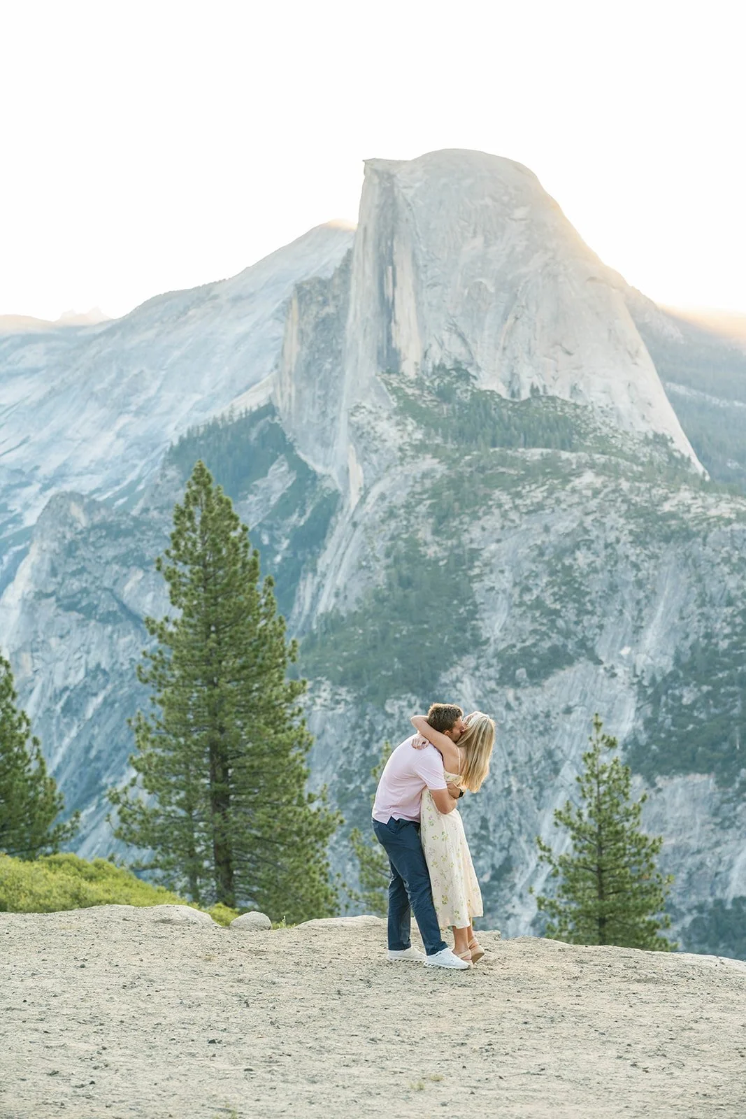 Couple hugs after their Yosemite proposal at sunrise