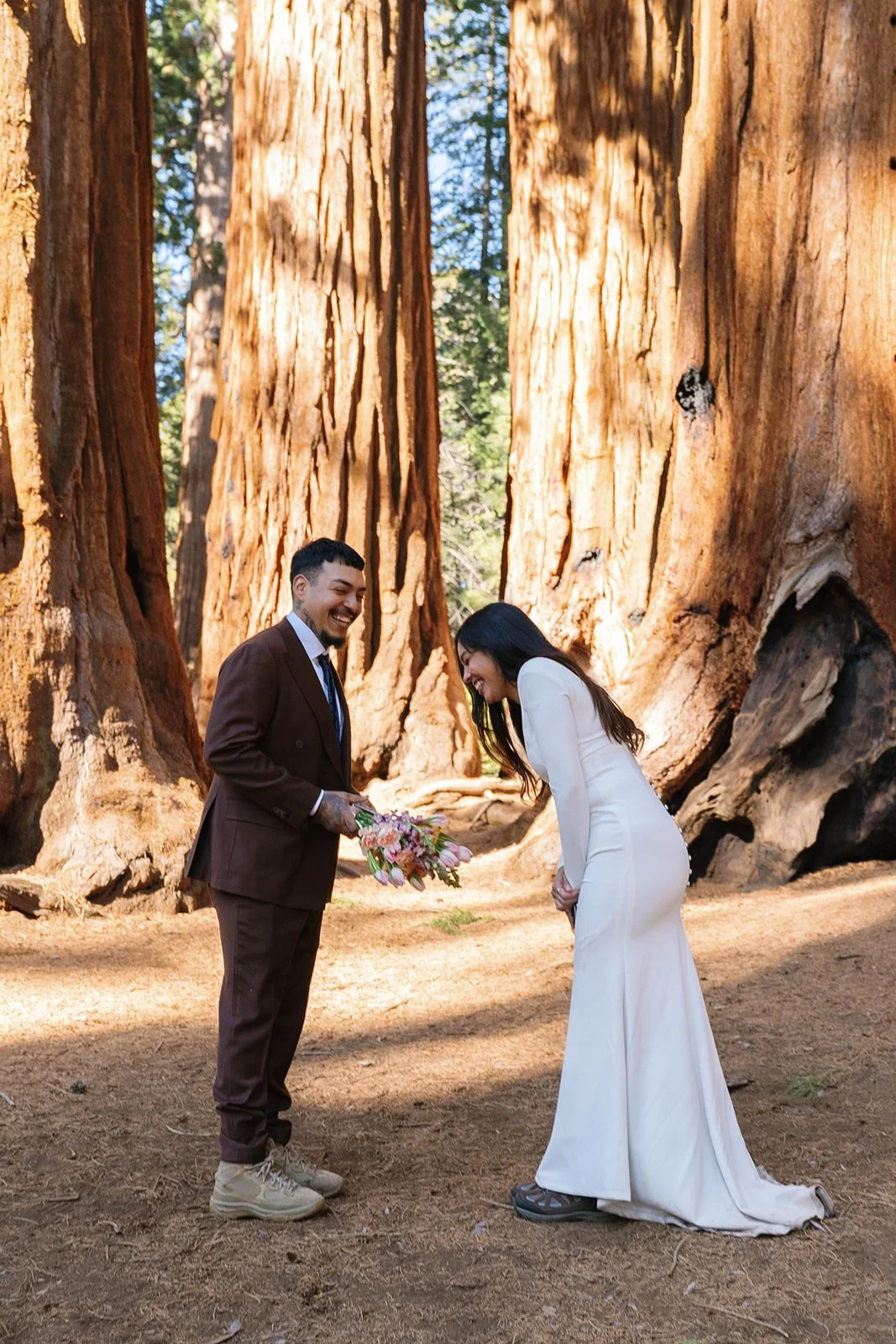 Bride and groom laugh while reading vows at their Sequoia elopement 