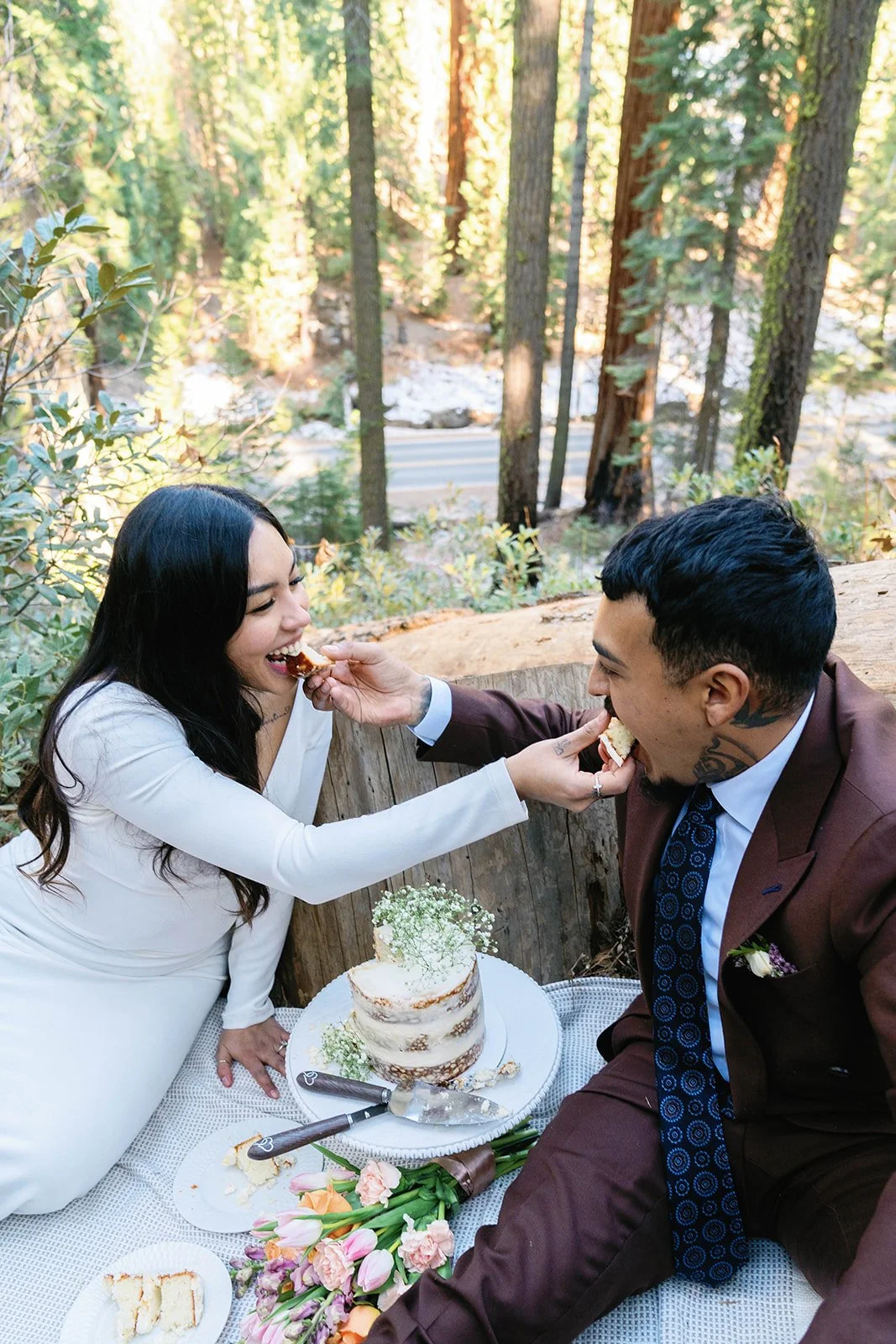 Bride and groom share cake at their Sequoia elopement