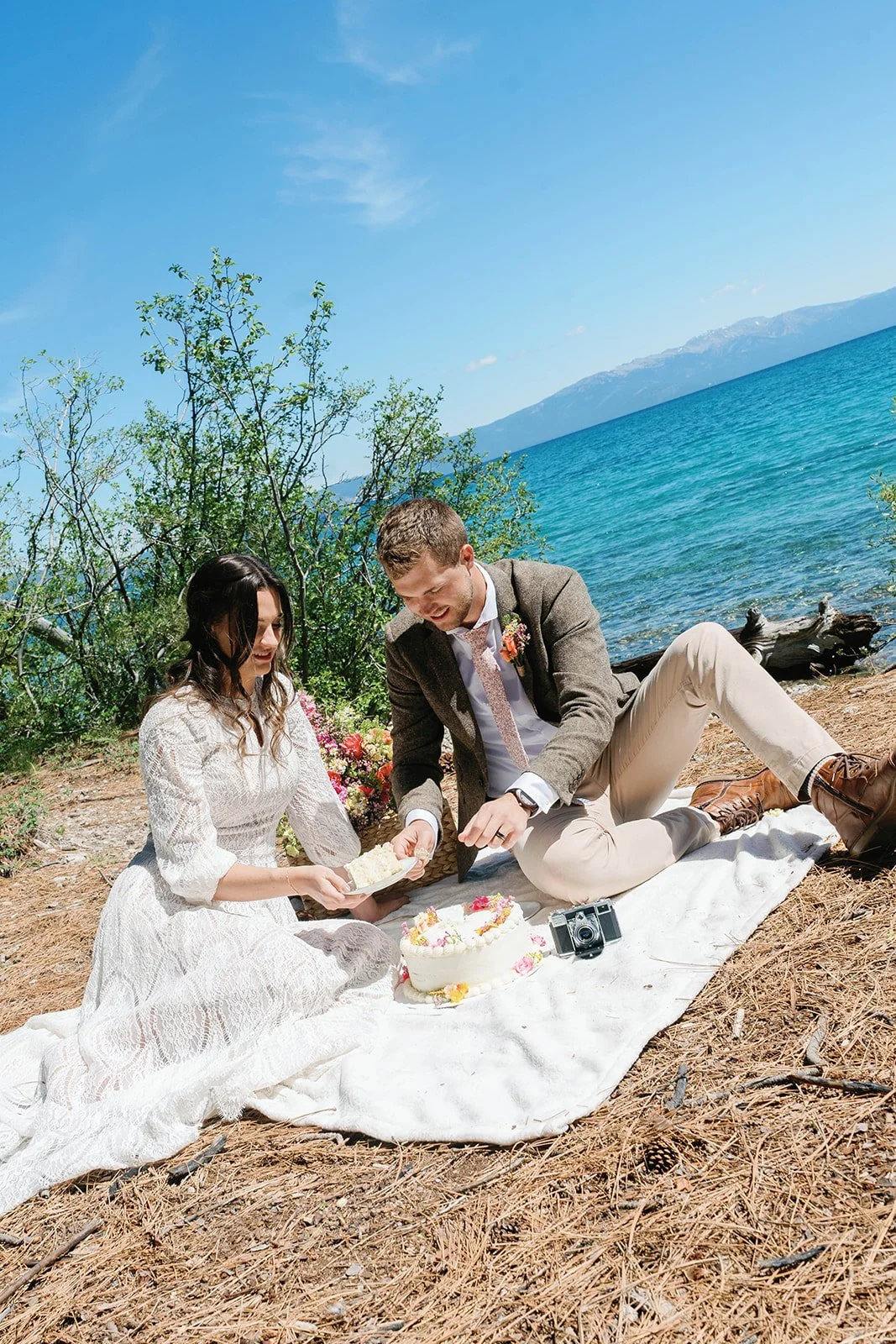 Bride and groom cut wedding cake at their Lake Tahoe elopement