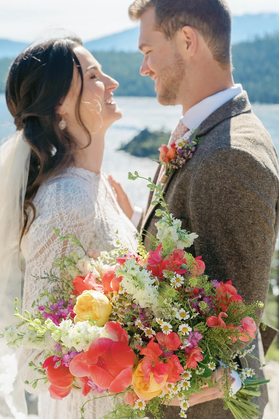 Bride holds colorful wedding bouquet at her Emerald Bay elopement