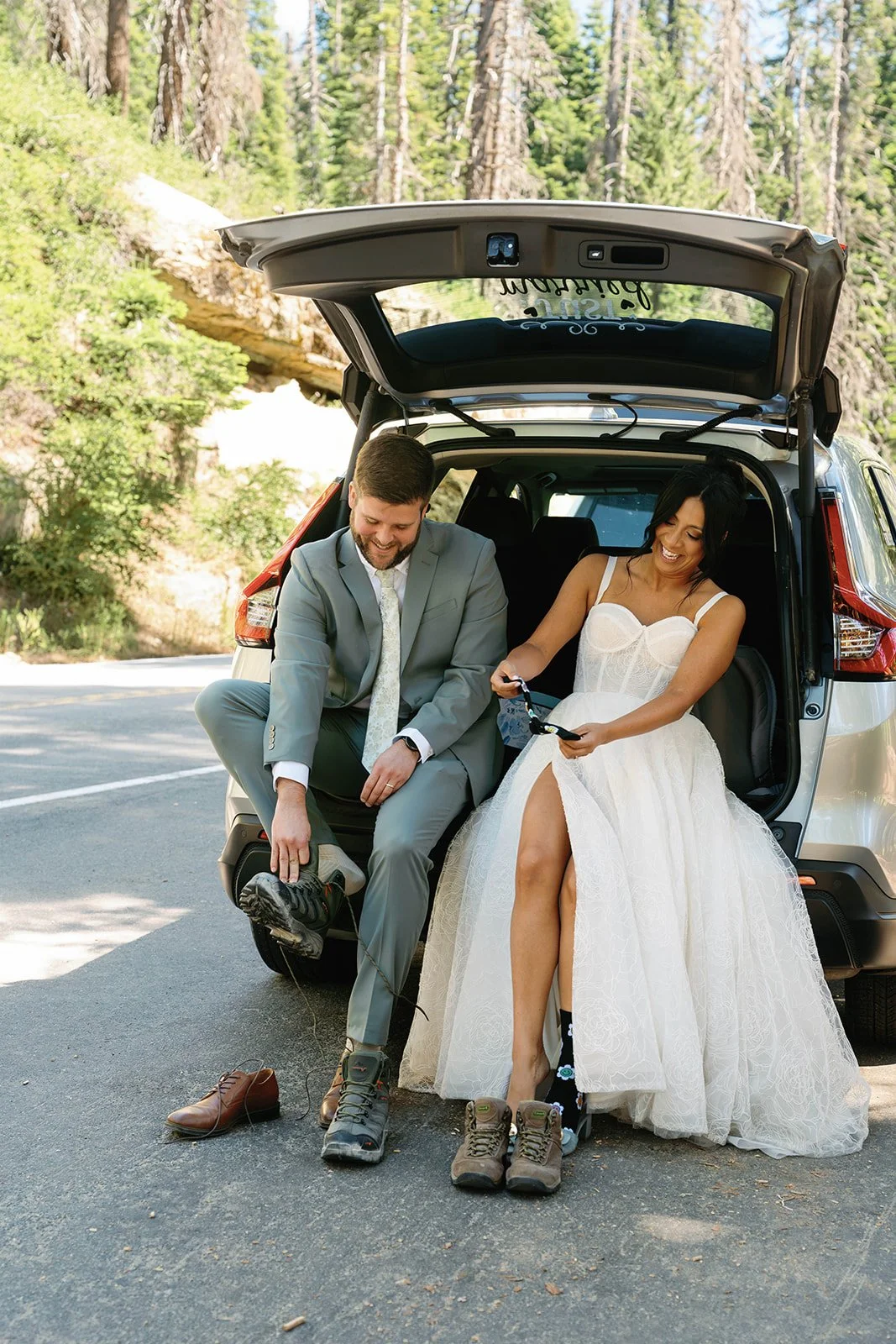 couple puts on hiking boots for their Sequoia elopement