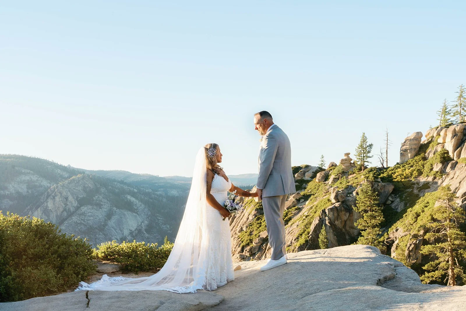 Bride and groom hold hands at their Yosemite weekend elopement