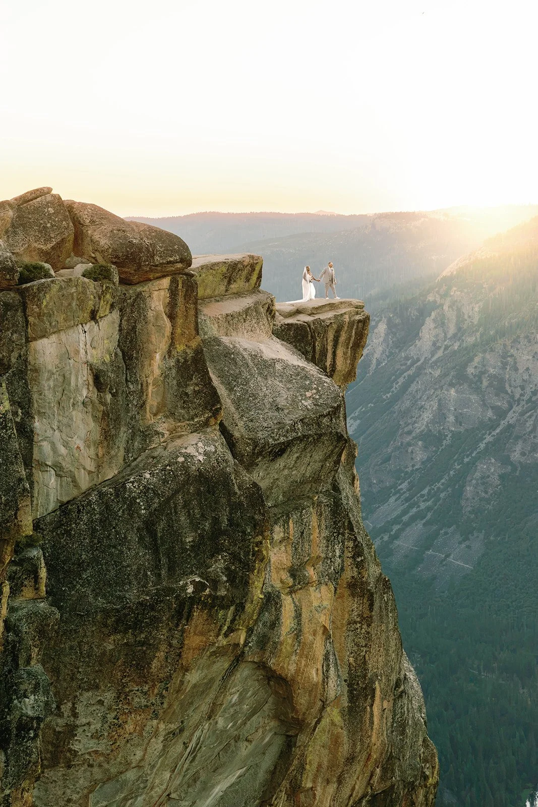 Bride and groom on cliff during Yosemite weekend elopement