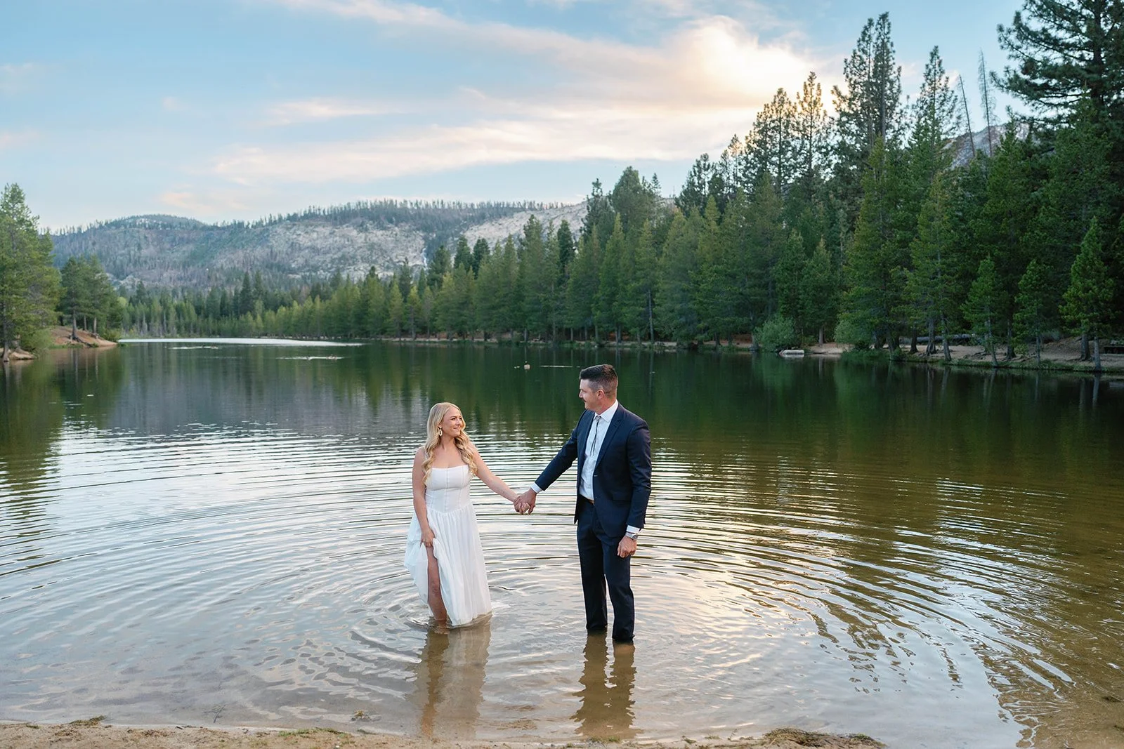 Couple dips feet into water at their Tahoe Paradise Park elopement
