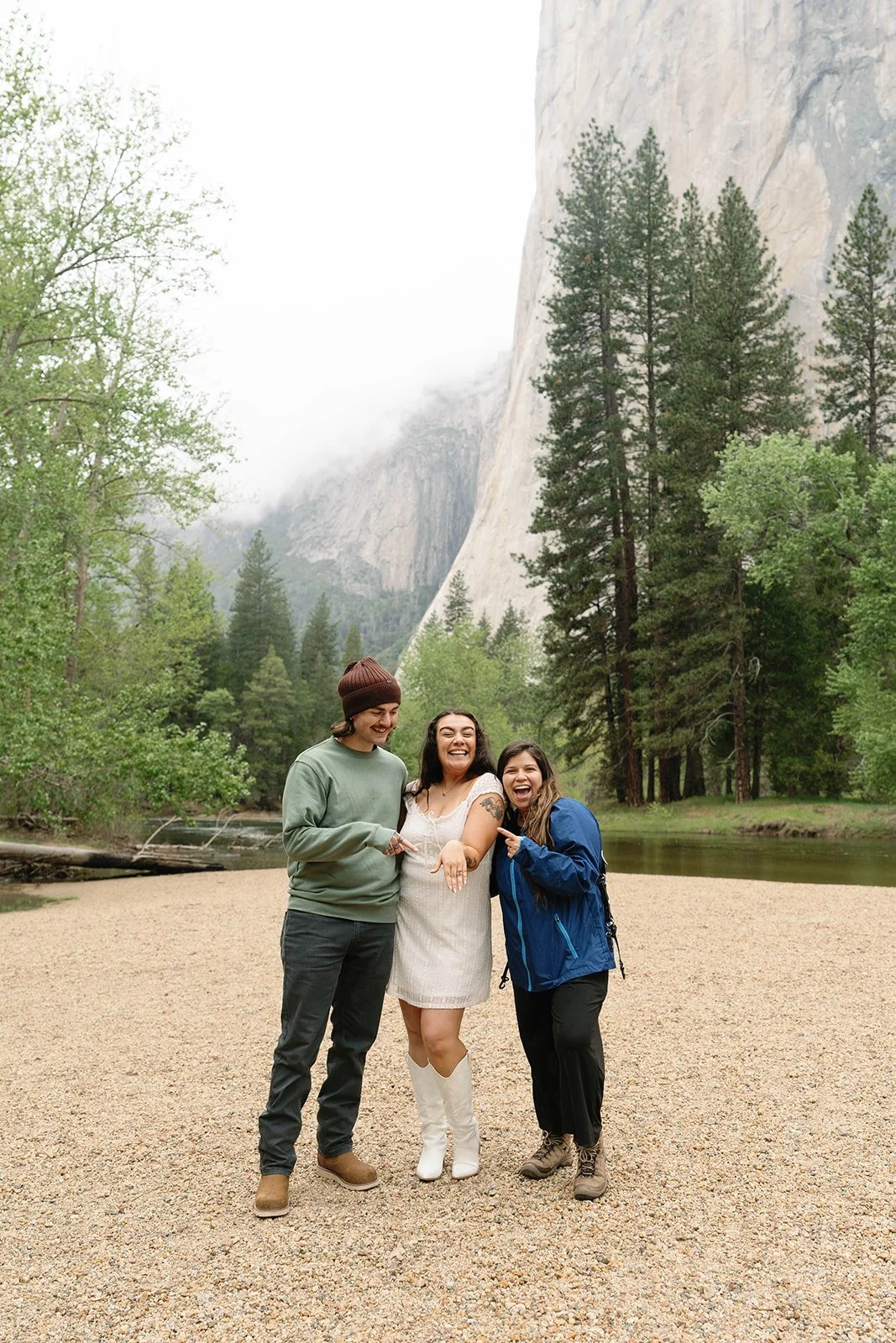 photographer with newly engaged couple at their Cathedral Beach engagement photos