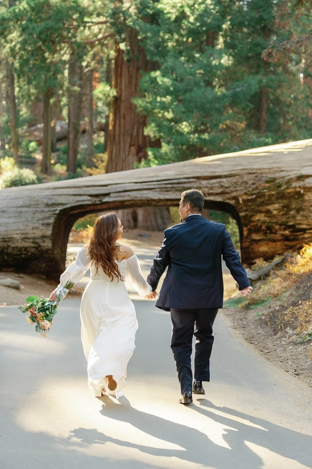 sequoia national park elopement excited couple at tunnel log