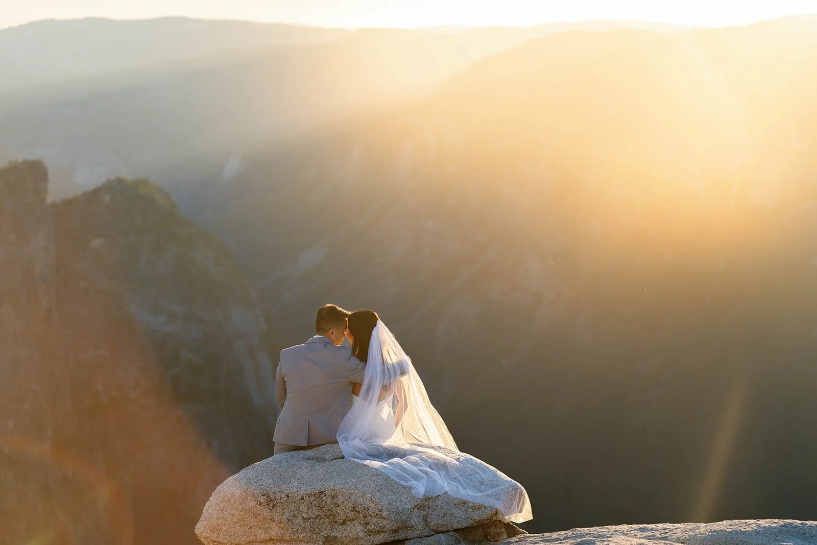 Bride and groom embrace at the best sunrise elopement location in Yosemite